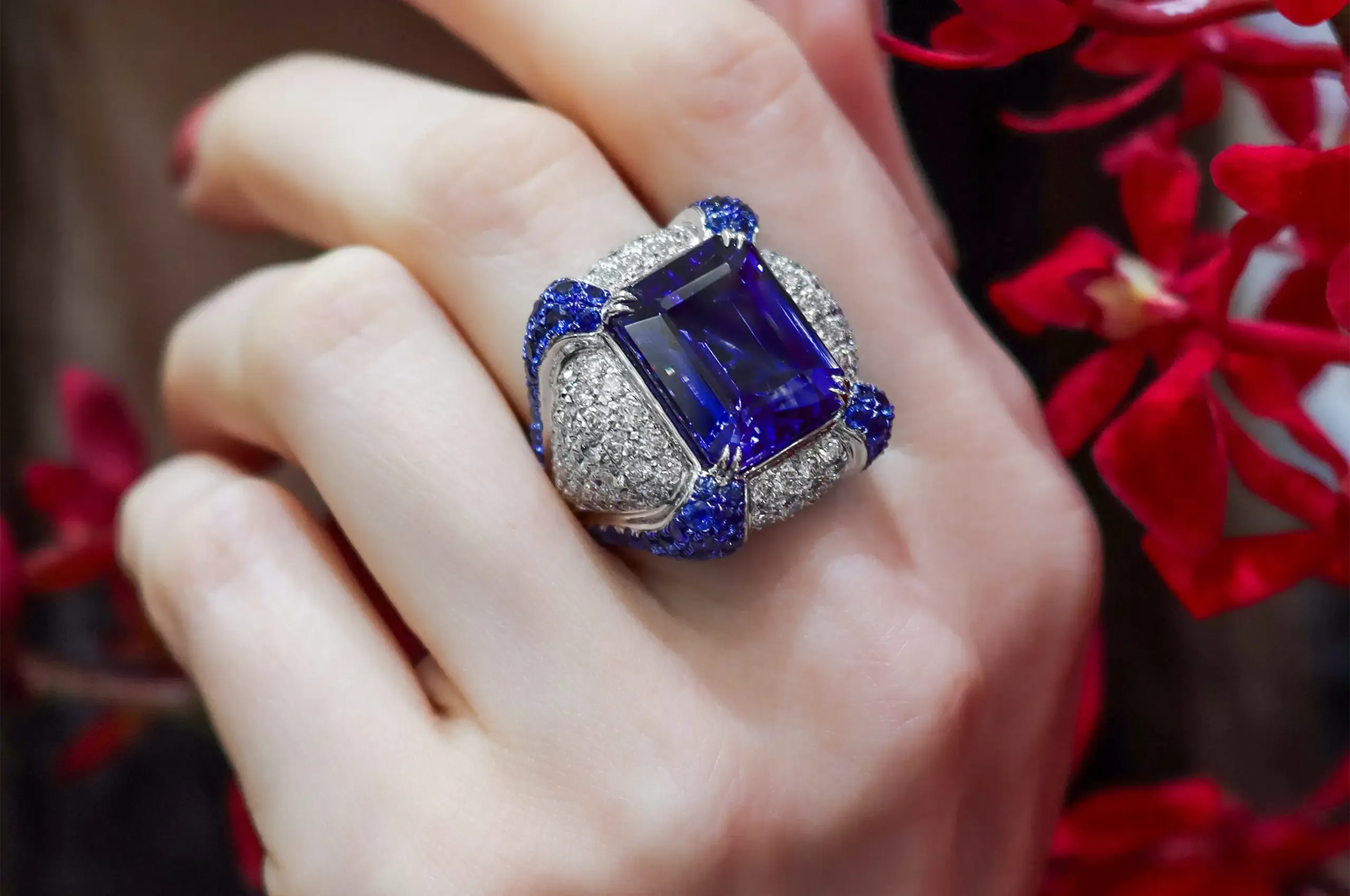 Sapphires and diamonds surround the 14.95-carat tanzanite, amplifying its intense violet-blue colour