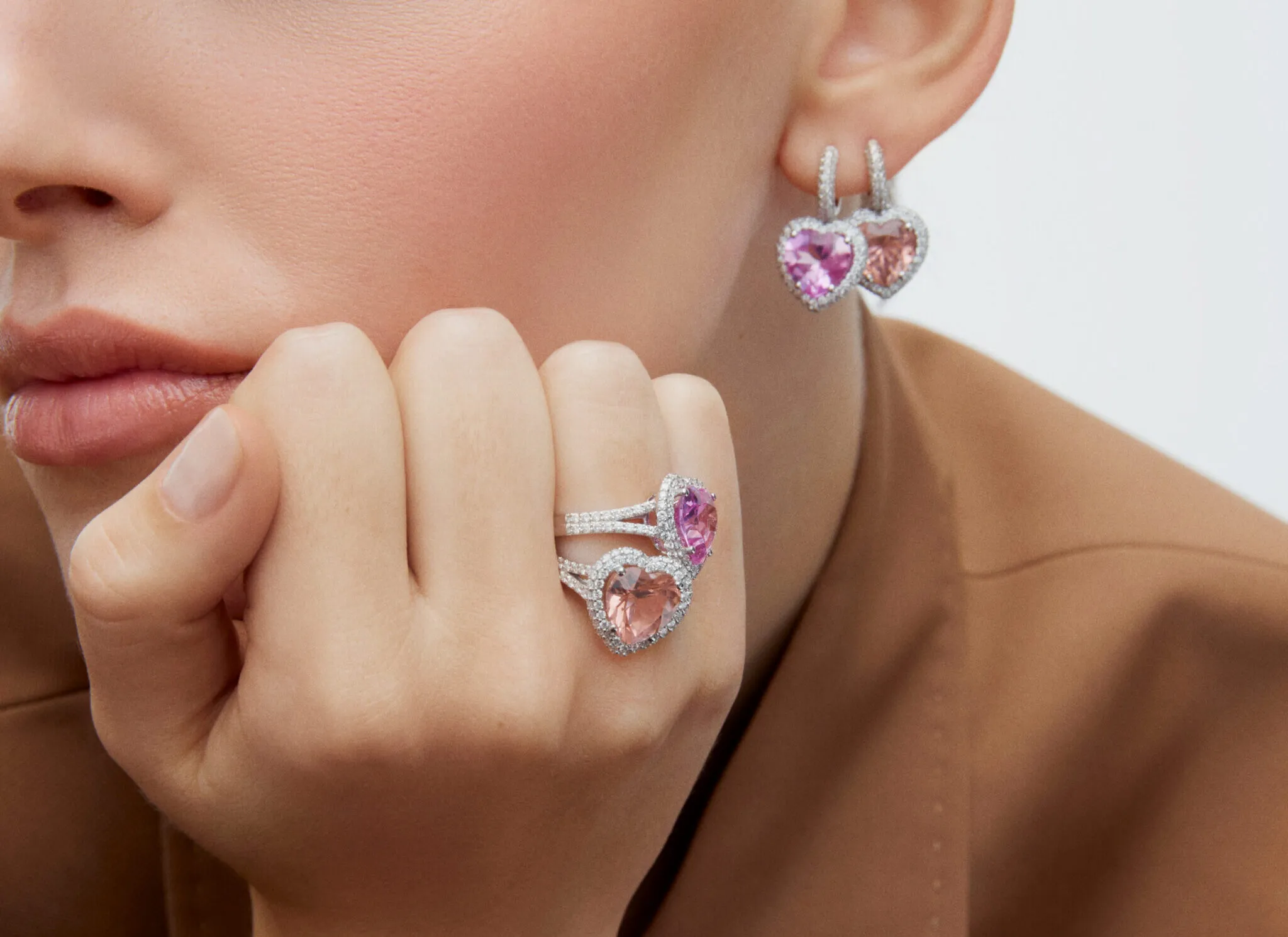 <p>A model wears jewellery by Aponine, including the Heart Drop earrings with 8.46 carats of morganite and a matching 4.90 carat morganite ring, both from the Sassy Classics collection</p>
