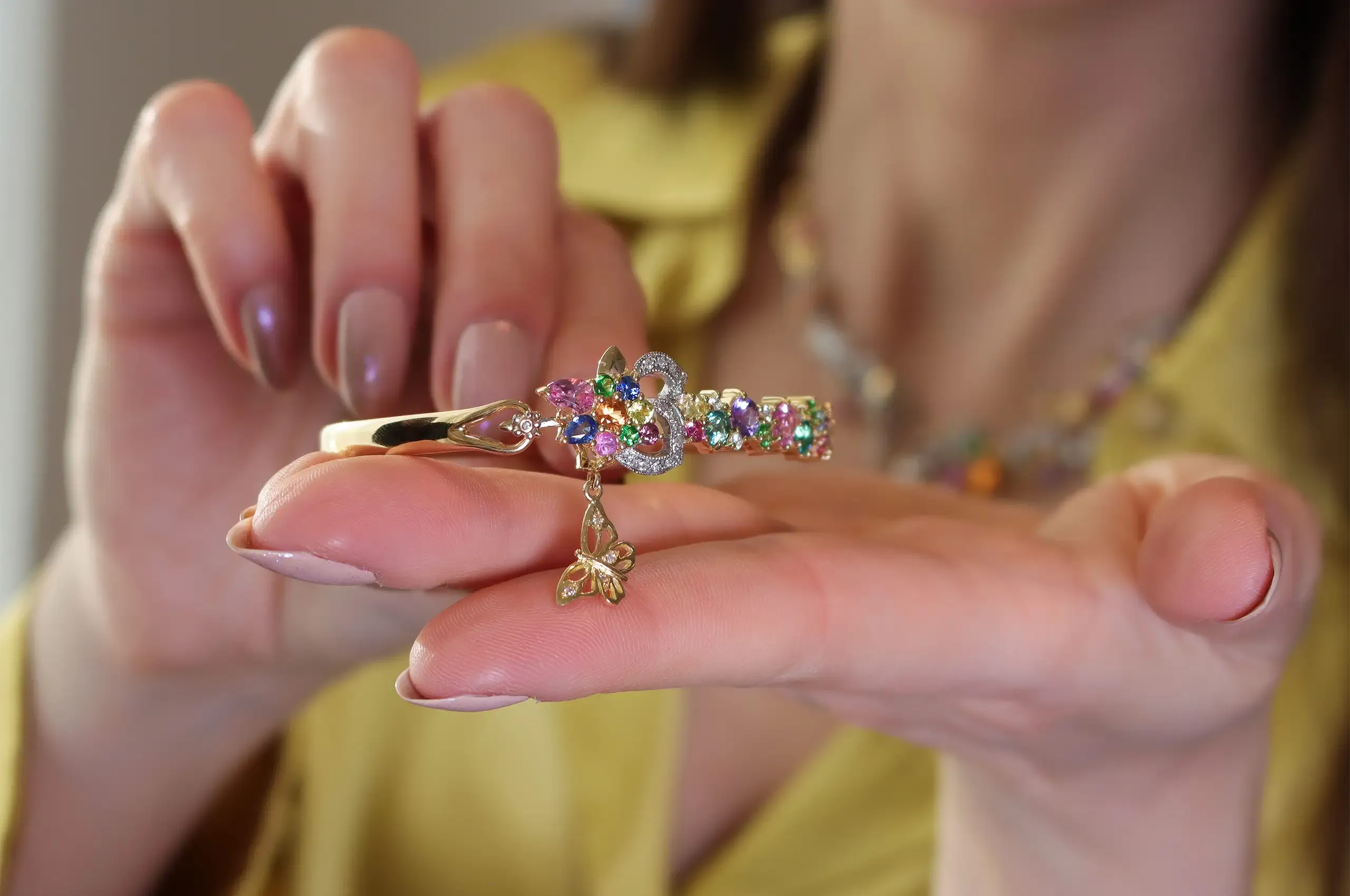 Artisans Bespoke Jewellers Borboleta bangle with sapphire, spinel, garnet and diamonds set in 18k yellow and white gold 