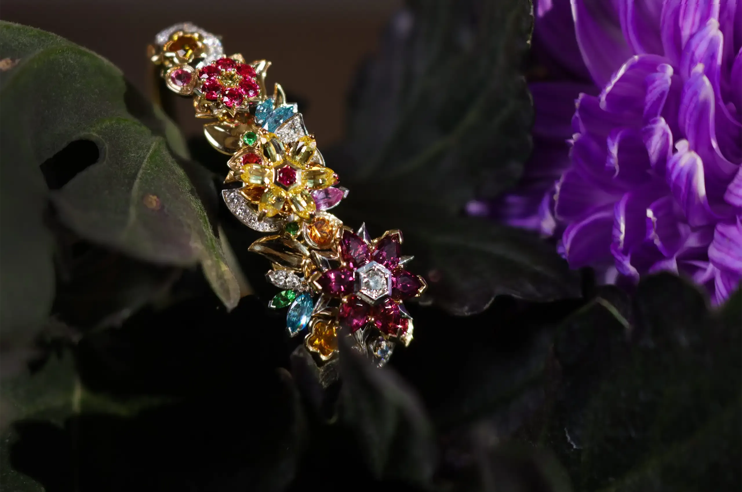 A closer look at the combinations of coloured gemstones in the floral-inspired Botanica bangle by Artisans Bespoke Jewellers, set with sapphires, spinels, garnets, zircons and diamonds in 18k yellow and white gold 