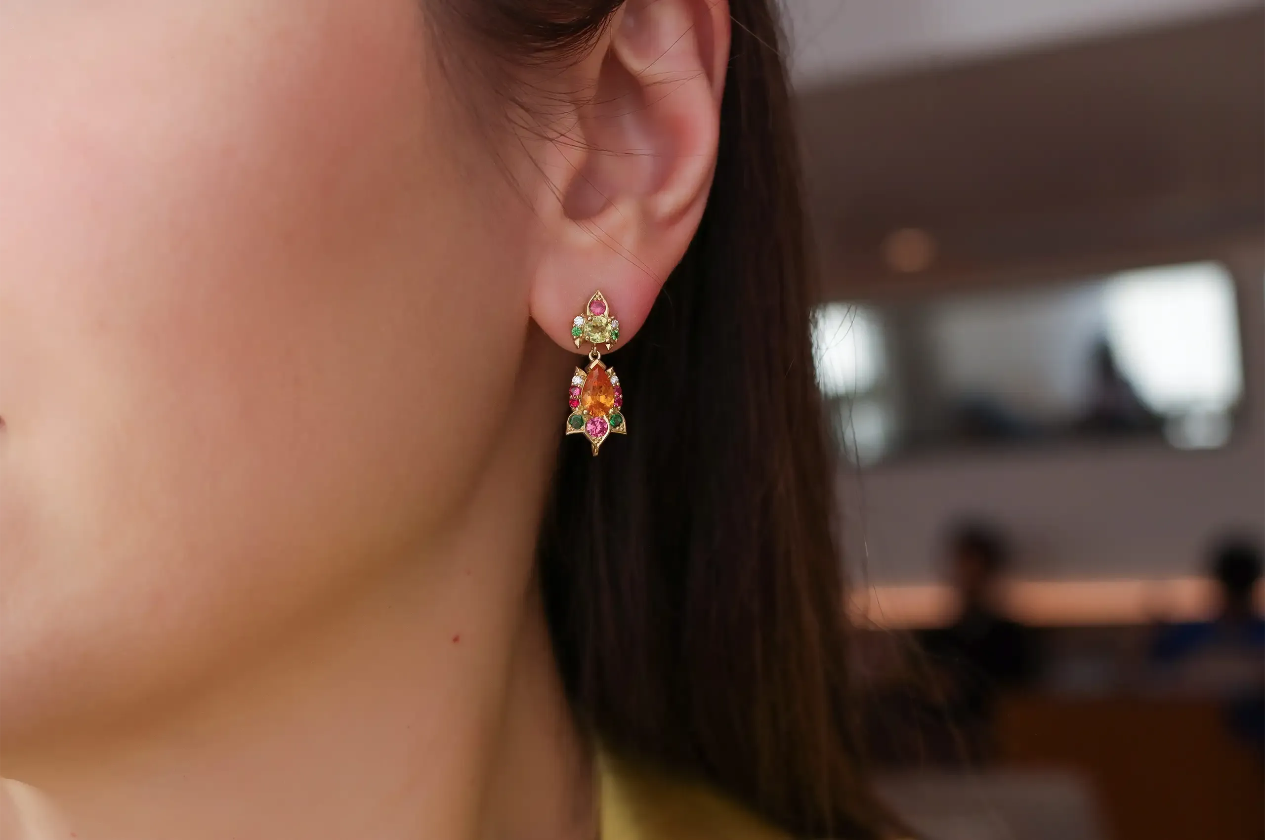 The stud portion of the Botanica earrings by Artisans Bespoke Jewellers, set with sapphire, spinel, garnet, zircon and diamonds in 18k yellow and white gold 
