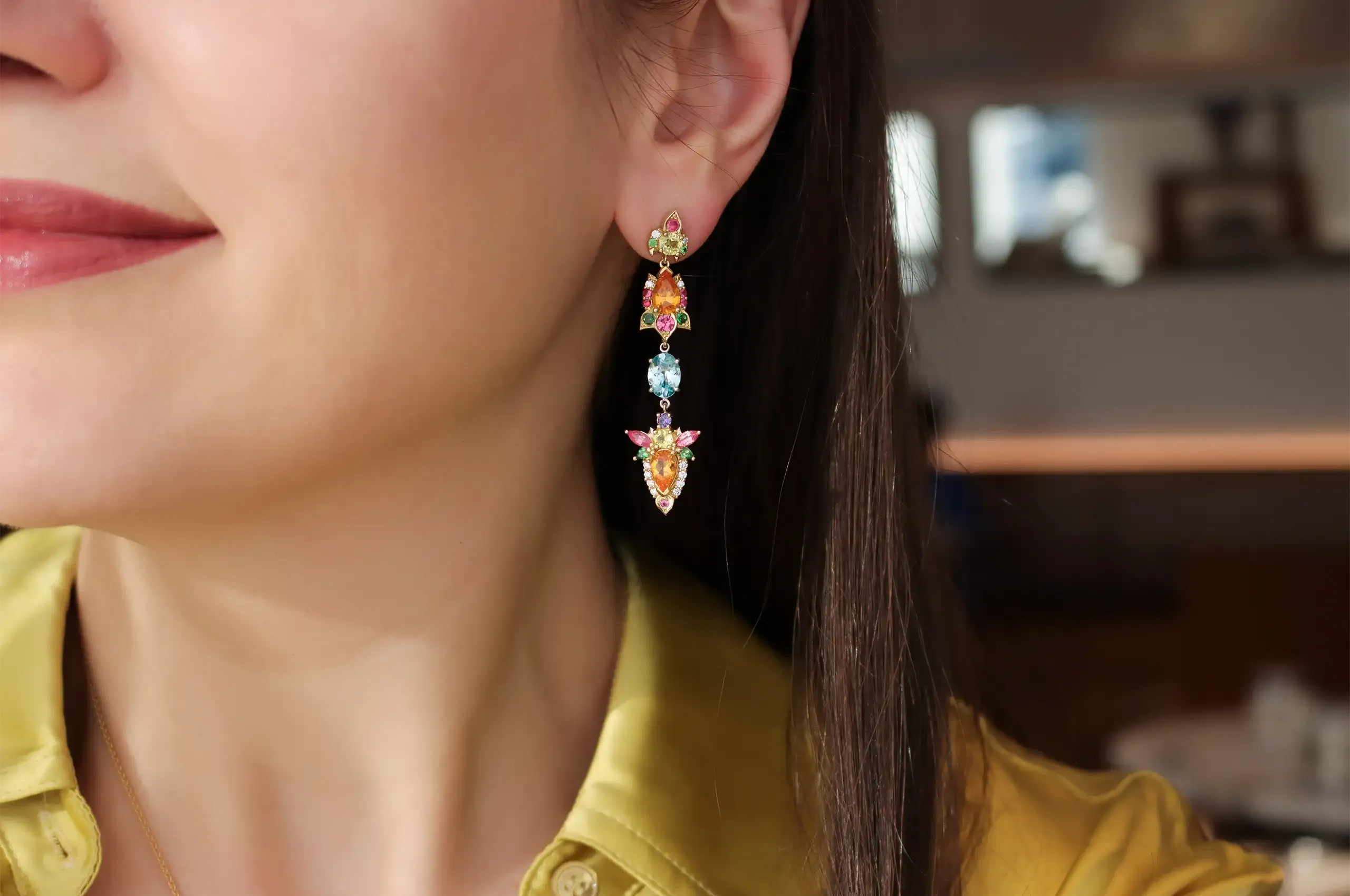 Katerina Perez wears the Artisans Bespoke Jewellers Botanica earrings with sapphire, spinel, garnet, zircon, diamonds and detachable oval-shaped blue zircon, sapphire, garnet and diamond drops, all set in 18k yellow and white gold 