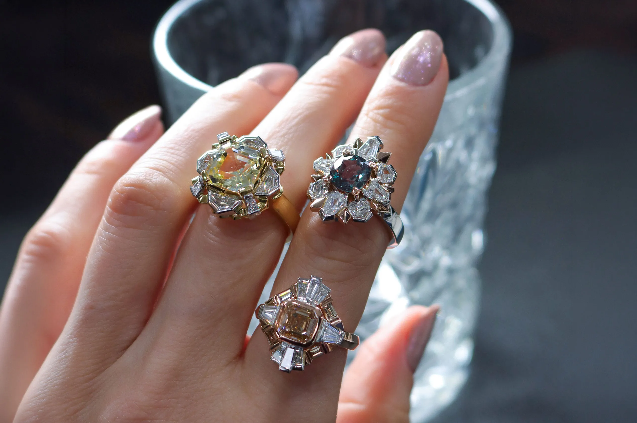 Artisans Bespoke Jewellers rings including (clockwise from left) the Empire Solis with a 5.60 carat Asscher-cut yellow sapphire and 1.05 carats of diamonds in 18k yellow and white gold; the Tsarina ring with a 2.28 carat cushion-cut alexandrite and 1.62 carats of diamonds in platinum and 18k rose gold, and the Empire Solis ring with 3.05 carats of Asscher- and baguette-cut diamonds in 18k rose gold and platinum