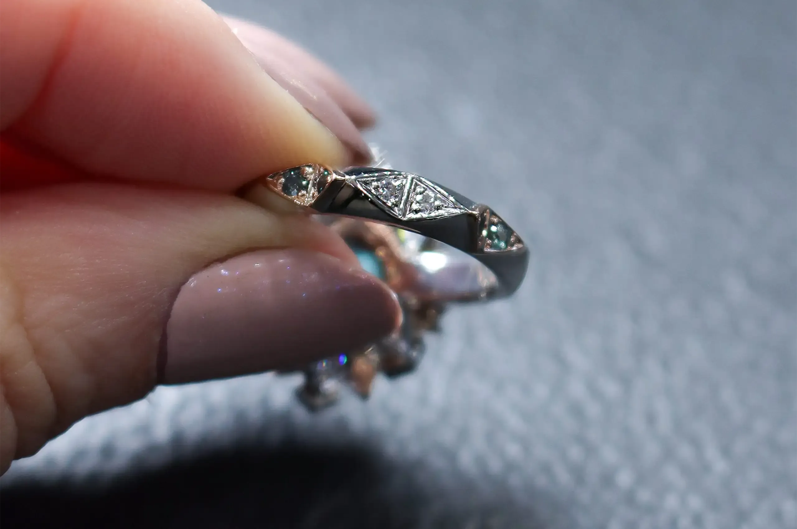 The hidden diamond and coloured gemstone details on a ring by Artisans Bespoke Jewellers