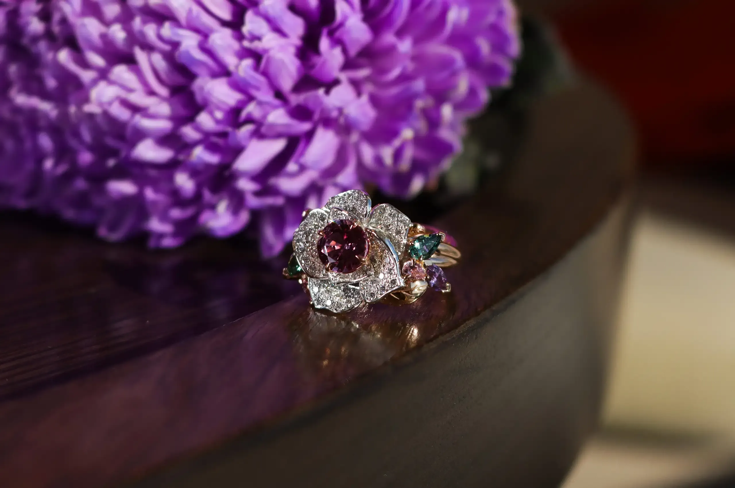 Artisans Bespoke Jewellers Botanica Lady Beetle ‘Rose’ ring with a 1.79 carat pink-purple sapphire surrounded by diamonds, and green, purple and pink sapphire leaves, set in 18k rose and white gold