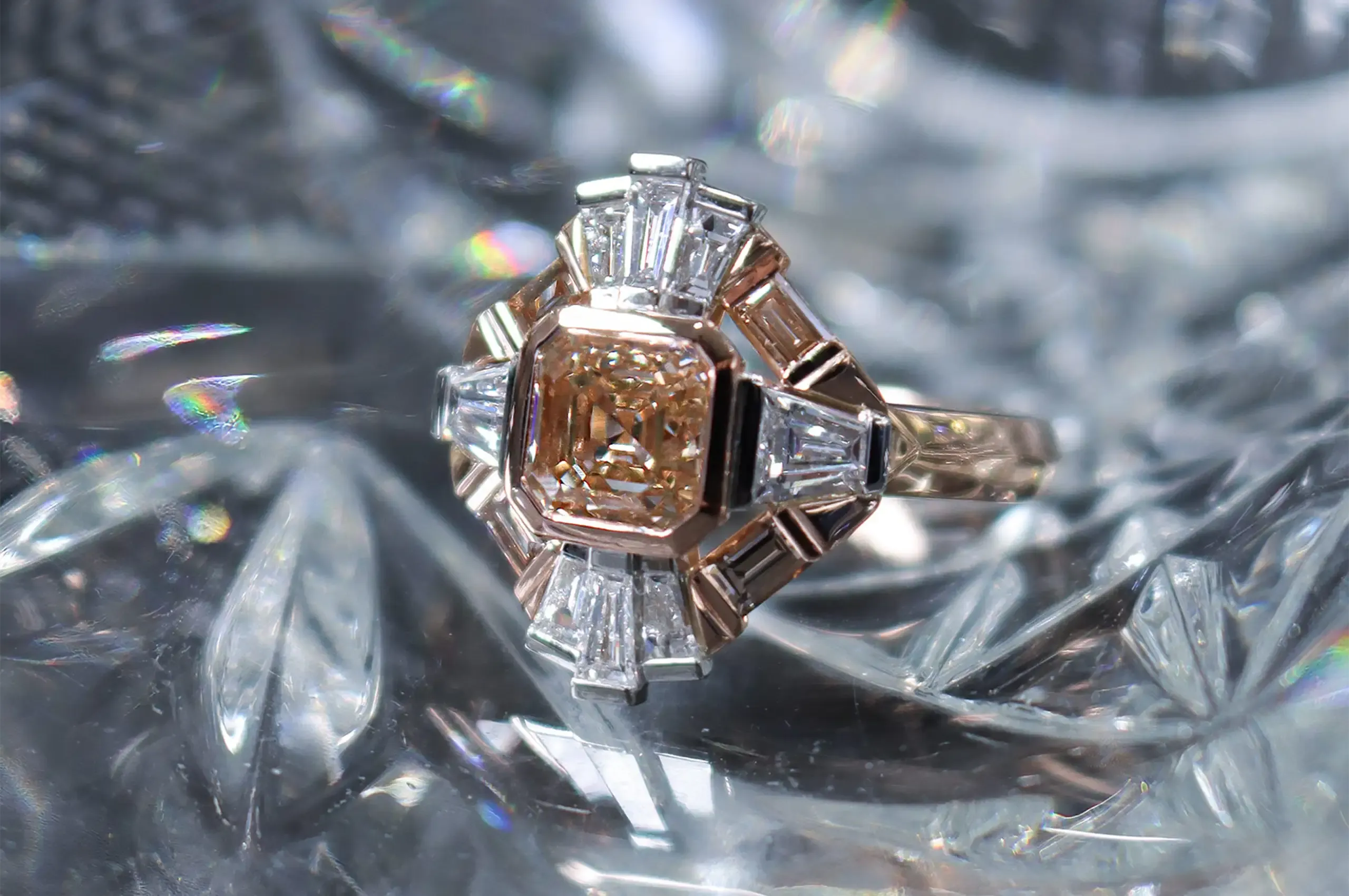 Artisans Bespoke Jewellers Empire Solis ring with a VVS2 Asscher-cut diamond centre stone surrounded by a geometric halo of baguette-cut diamonds, set in 18ct rose gold and platinum 