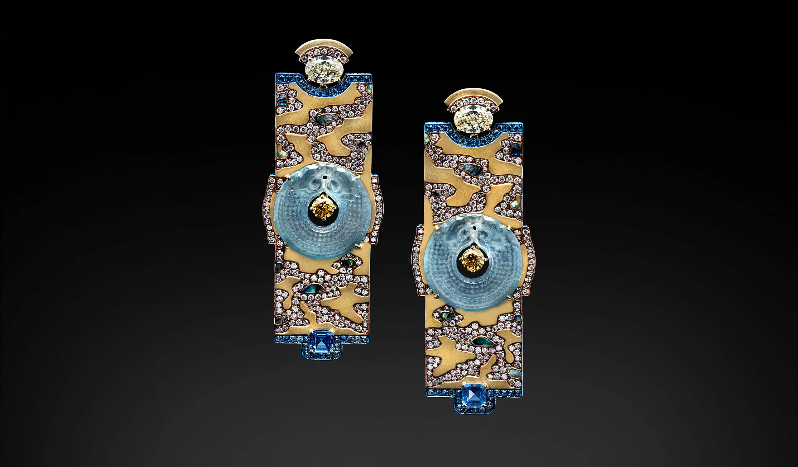 <p>Austy Lee The Dragon in the River earrings from The Jade Dynasty collection with Burmese greyish blue jades, fancy yellow diamonds, blue sapphires, abalone shells, and champagne diamonds set in 18k yellow gold </p>