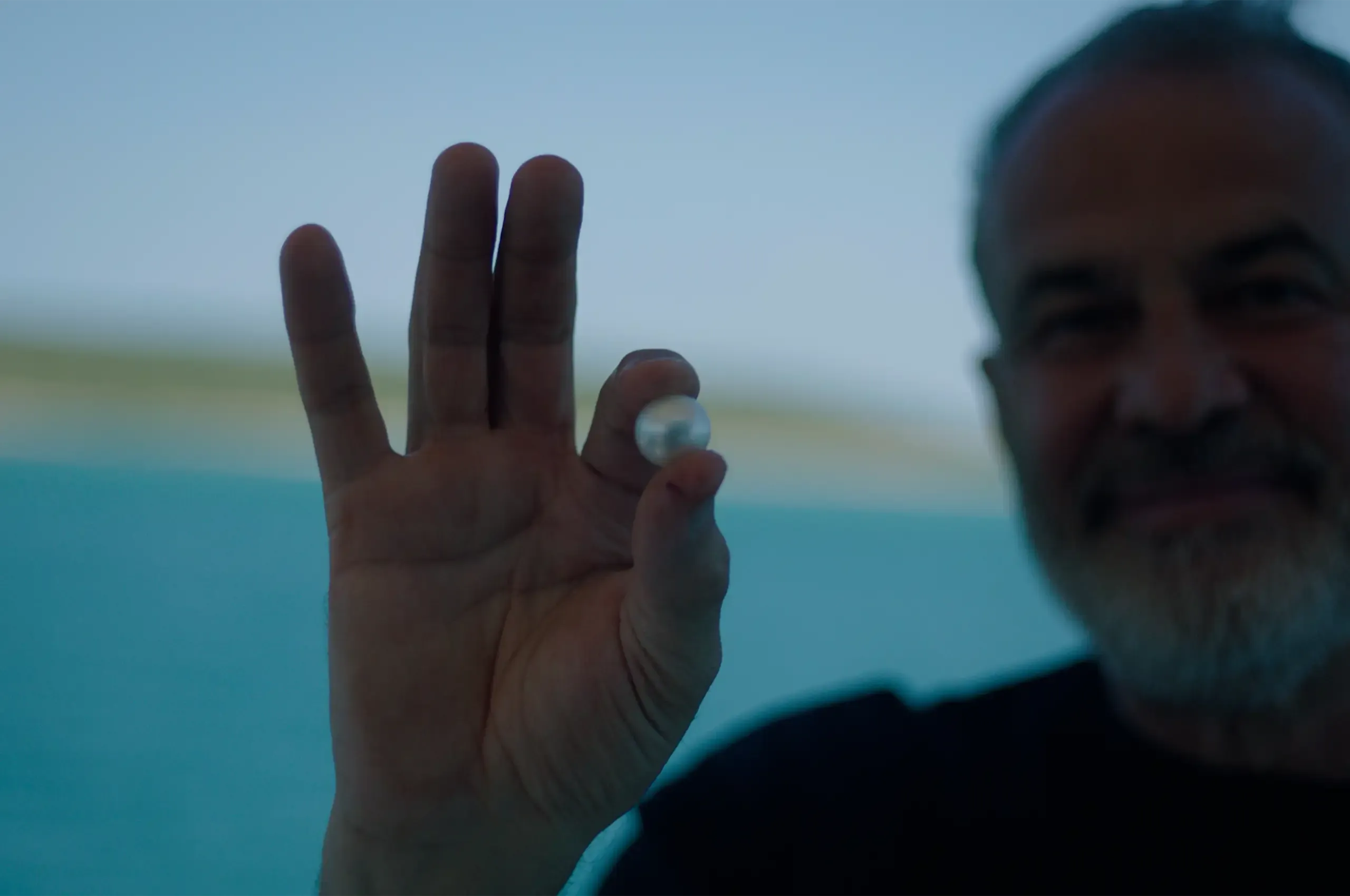 AUTORE founder Rosario Autore holding a South Sea pearl