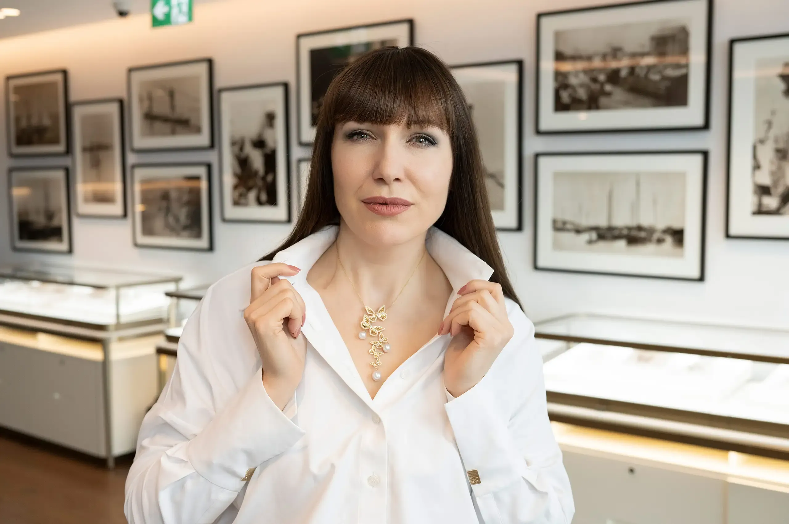 Katerina wearing AUTORE’s Papillon necklace, with white South Sea pearls and diamond-set butterfly wings in 18K yellow gold, which can also be worn as a brooch