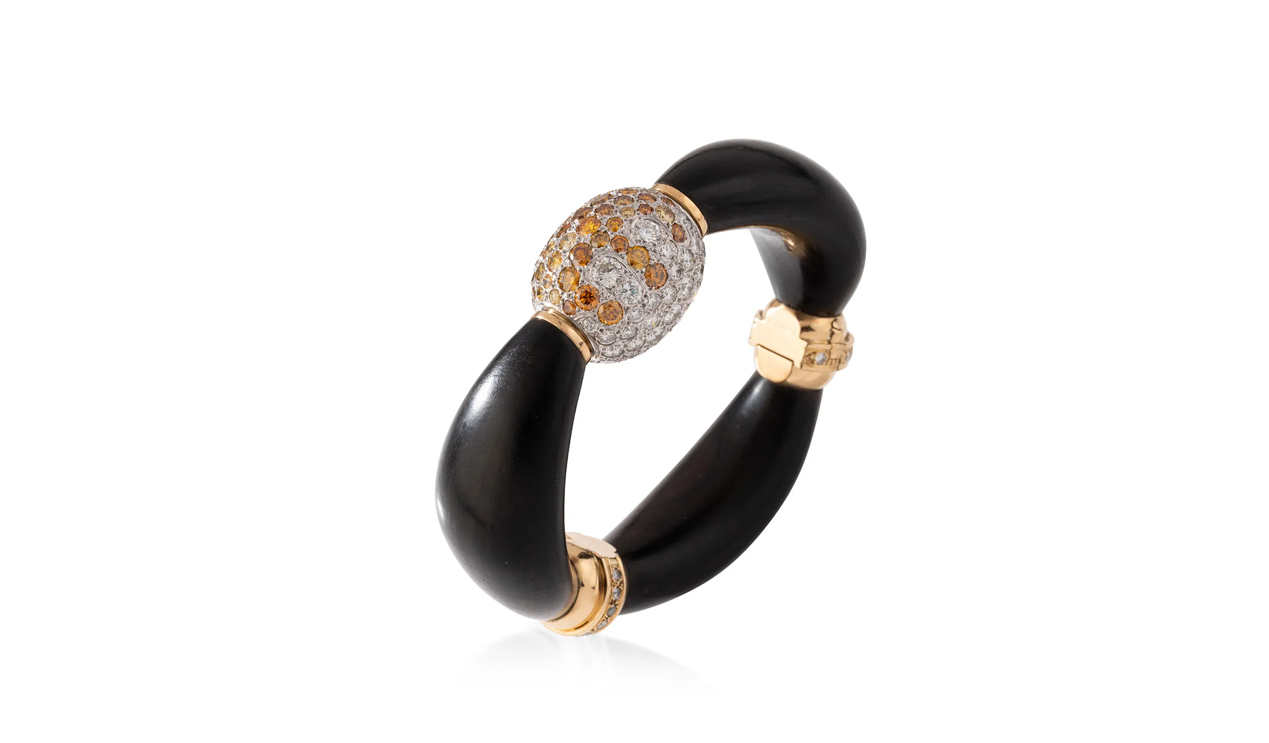<p>Réne Boivin bracelet in yellow gold and ebony wood, with a pivoting oblong demi-sphere pavé-set with white and golden diamonds, circa 1975, designed by MarieCaroline de Brosses</p>
