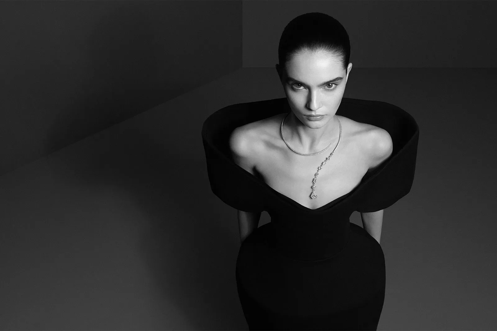 <p>A model wears The Spark Question Mark necklace from the Boucheron Histoire de Style ‘Nom: Boucheron Prénom: Frédéric’ High Jewellery collection, complemented with a custom-made black gown</p>
