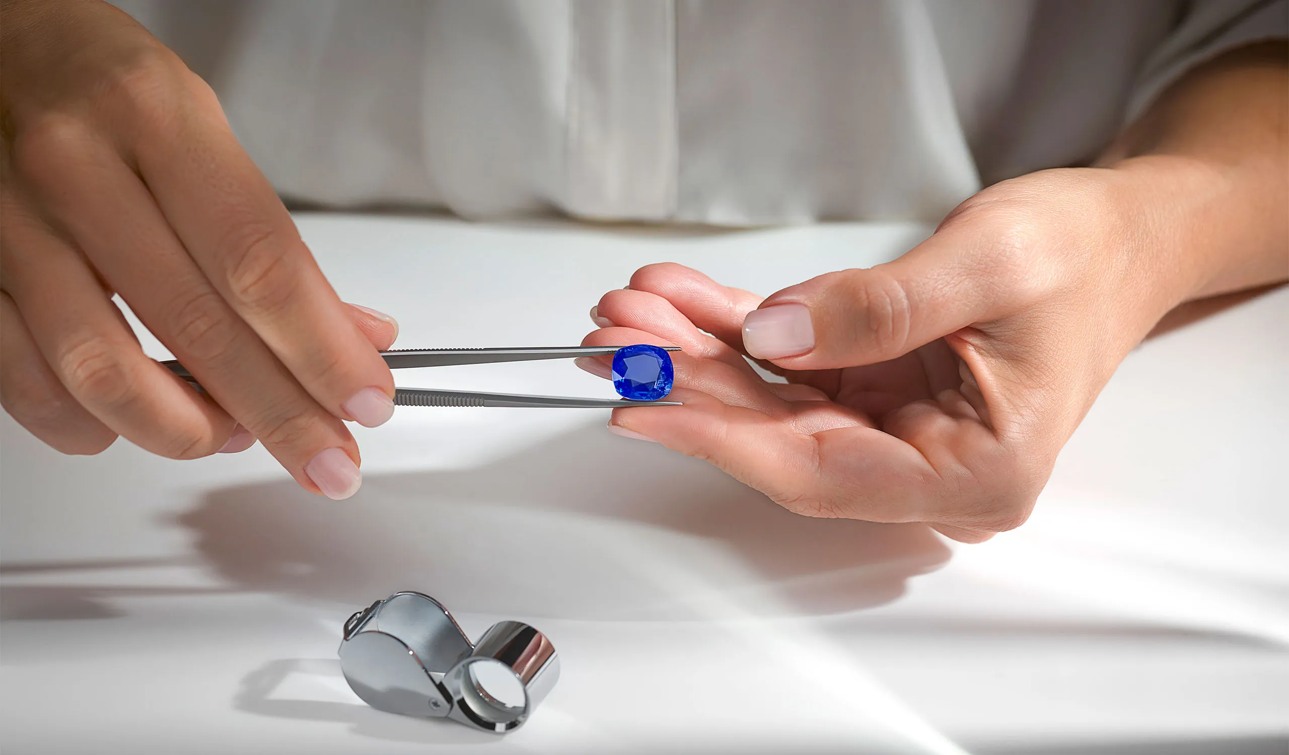 <p>The 14.01ct cushion-cut Madagascan sapphire centre stone</p>
