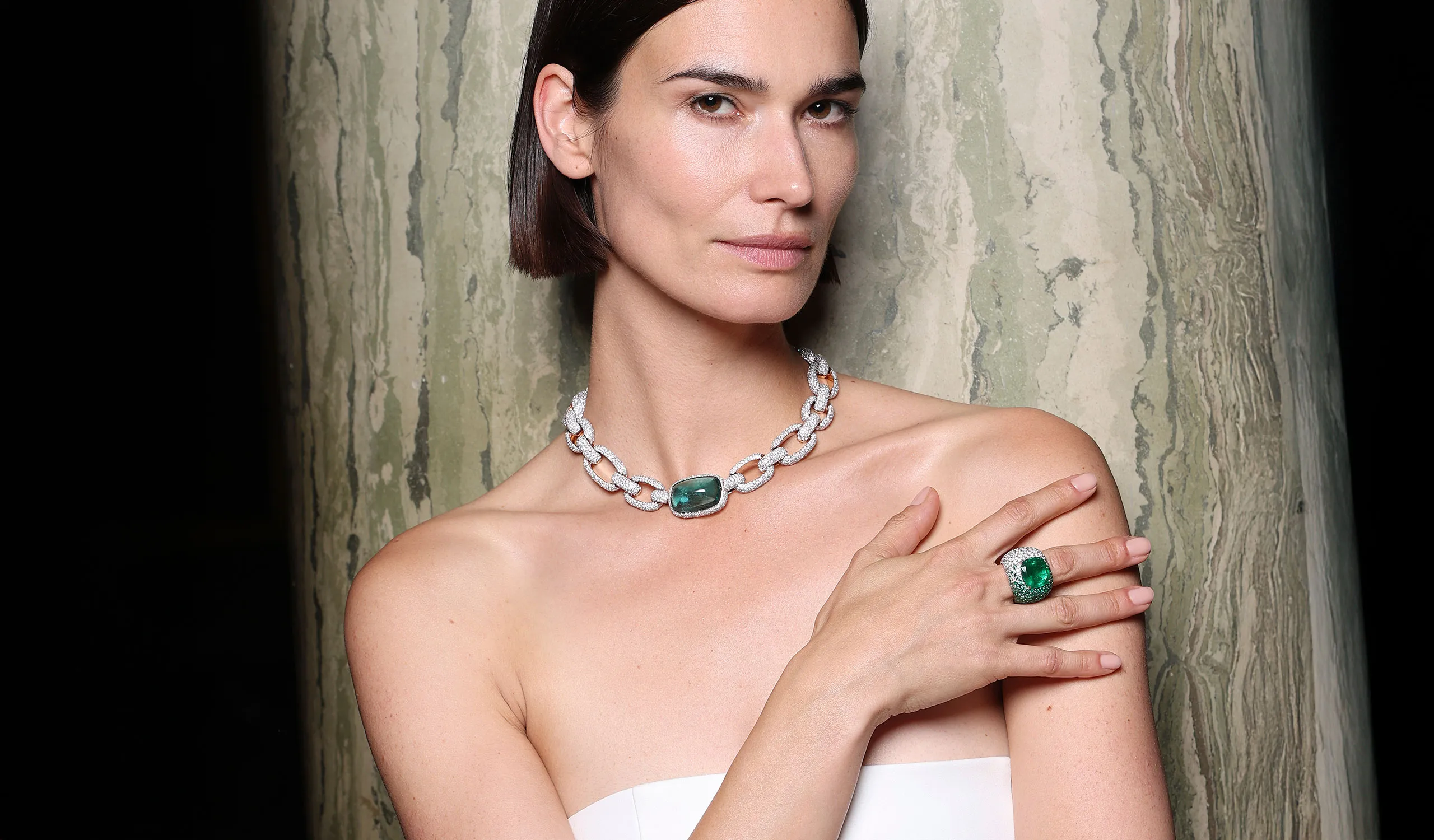 <p>A model wears pieces from the Pomellato‘Collezione 1967’ High Jewellery collection, including the Hypnotic Beryl necklace and the Iconica Extreme ring with a 12.27-carat cushion-cut emerald</p>