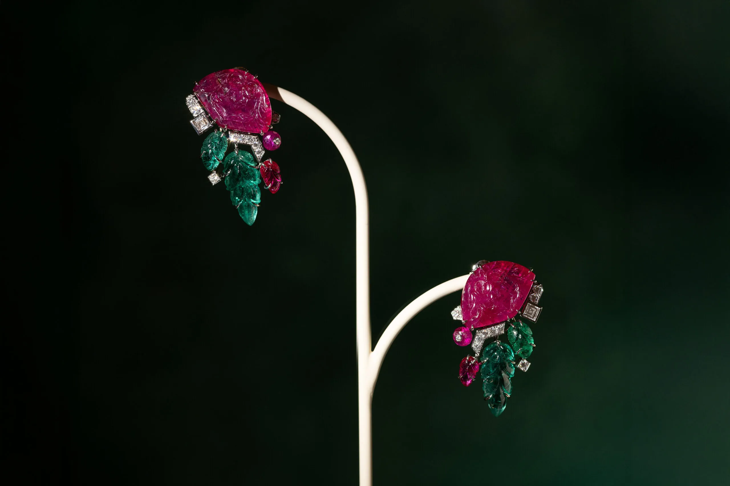 <p>Cartier earrings with two carved rubies totalling 24.05 carats, two emerald leaves totalling 9.93 carats, plus further emeralds, ruby beads, square-shaped diamonds and brilliant-cut diamonds, set in platinum, part of the En Équilibre High Jewellery collection</p>