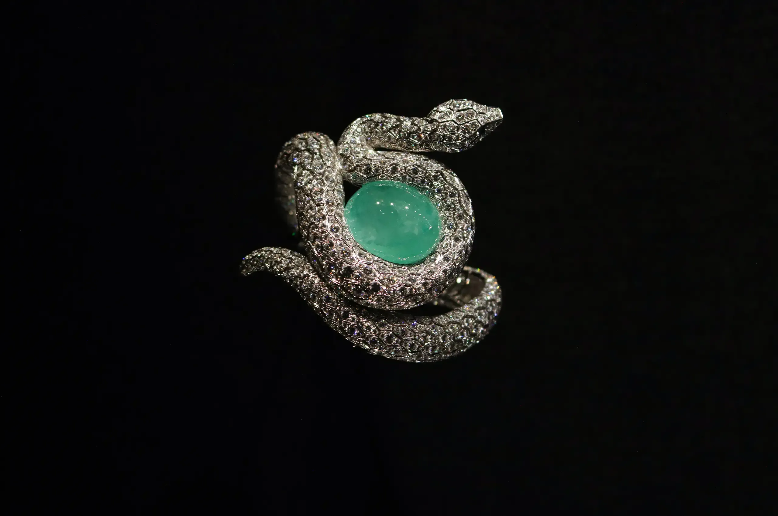 Cartier Snake bracelet, 2014, set with a 53.78-carat cabochon emerald and brilliant-cut diamonds, with an articulated snake’s head. Cartier Collection