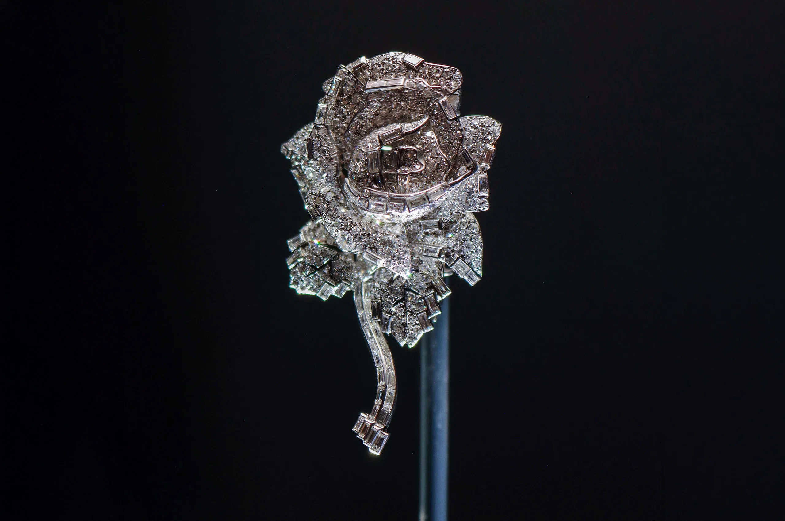 Cartier ‘Rose’ clip brooch, 1938, a three-dimensional composition of old-, baguette- and single-cut round diamonds that combines geometric structure with naturalistic form. Cartier Collection