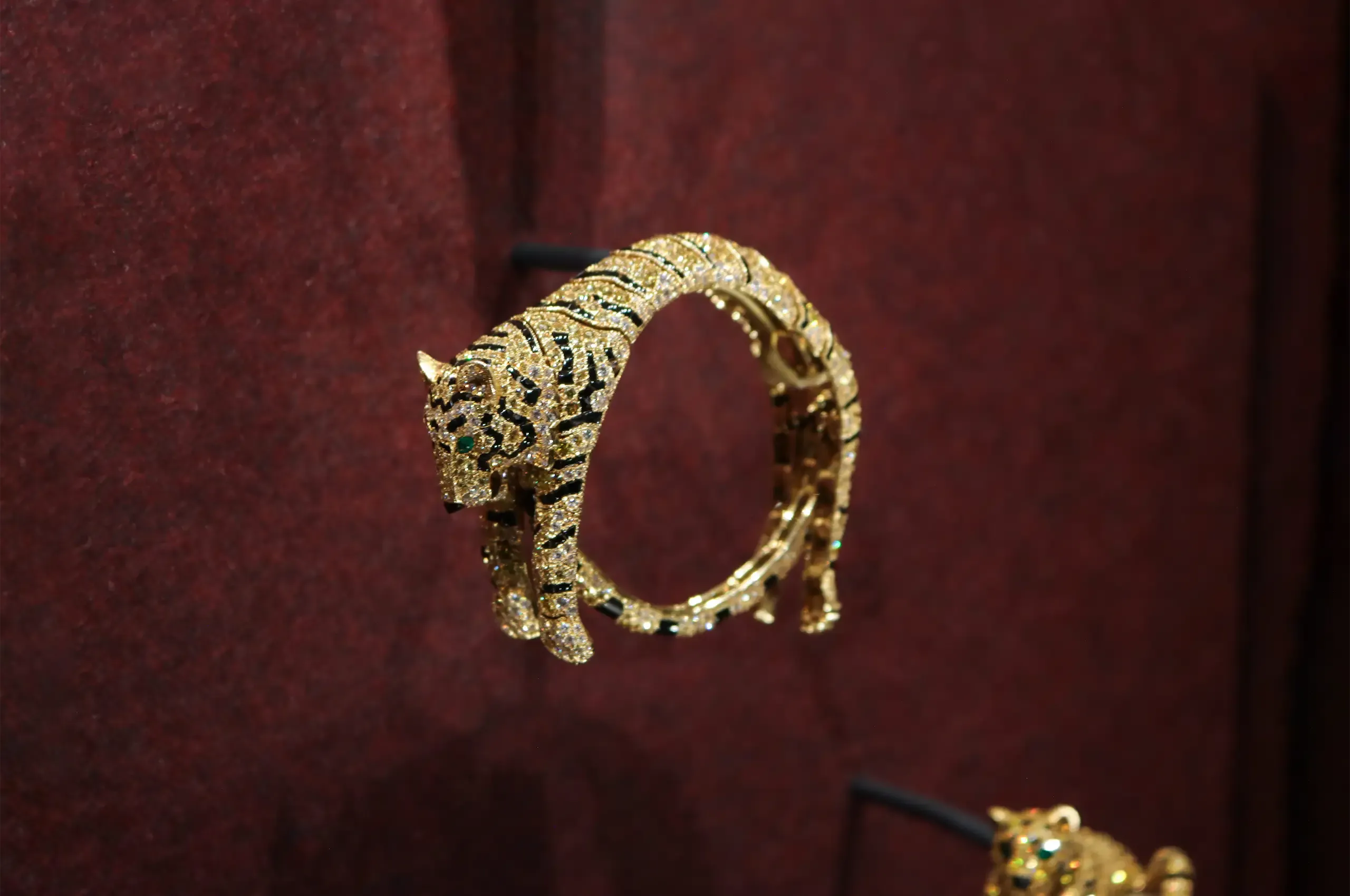 Cartier Tiger bracelet, 1956, created for the Duchess of Windsor, with an articulated body set with yellow and colourless diamonds, onyx stripes and emerald eyes
