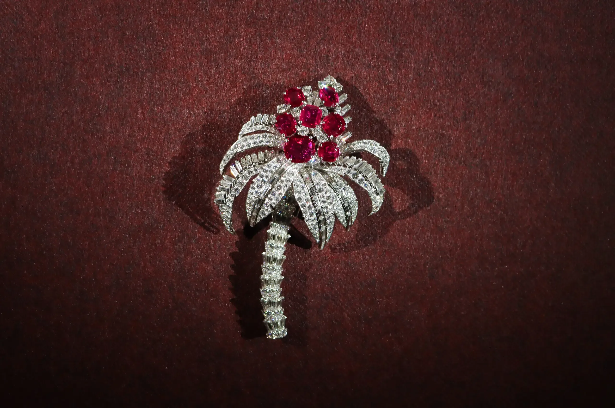 Cartier Palm Tree clip brooch, 1957, a special order set with seven Burmese rubies totalling 23.10 carats and diamonds, with an articulated diamond-set trunk. Cartier Collection
