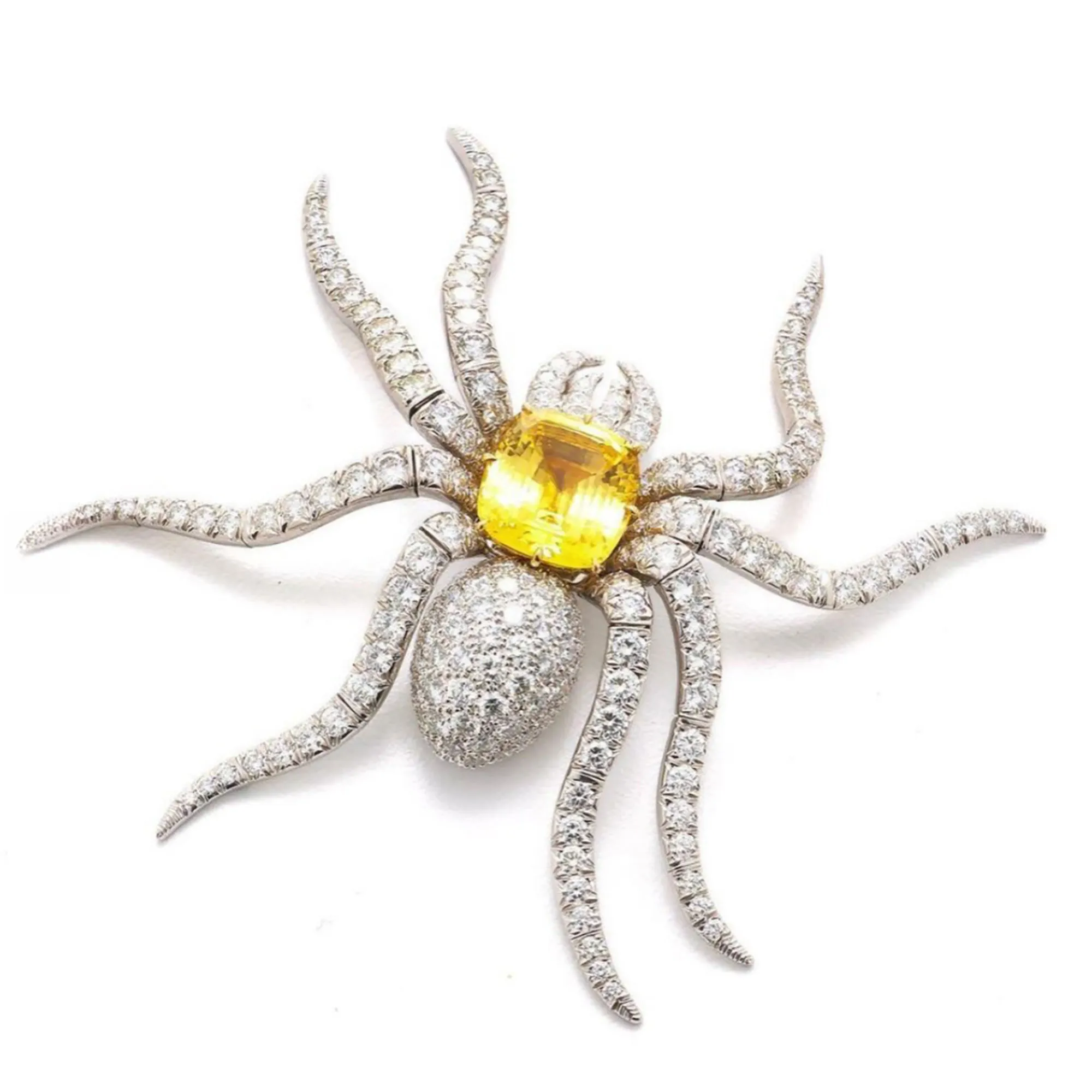 An archival 1990s David Webb spider brooch, featuring articulated diamond-set legs and a detachable yellow sapphire, worn on the red carpet.