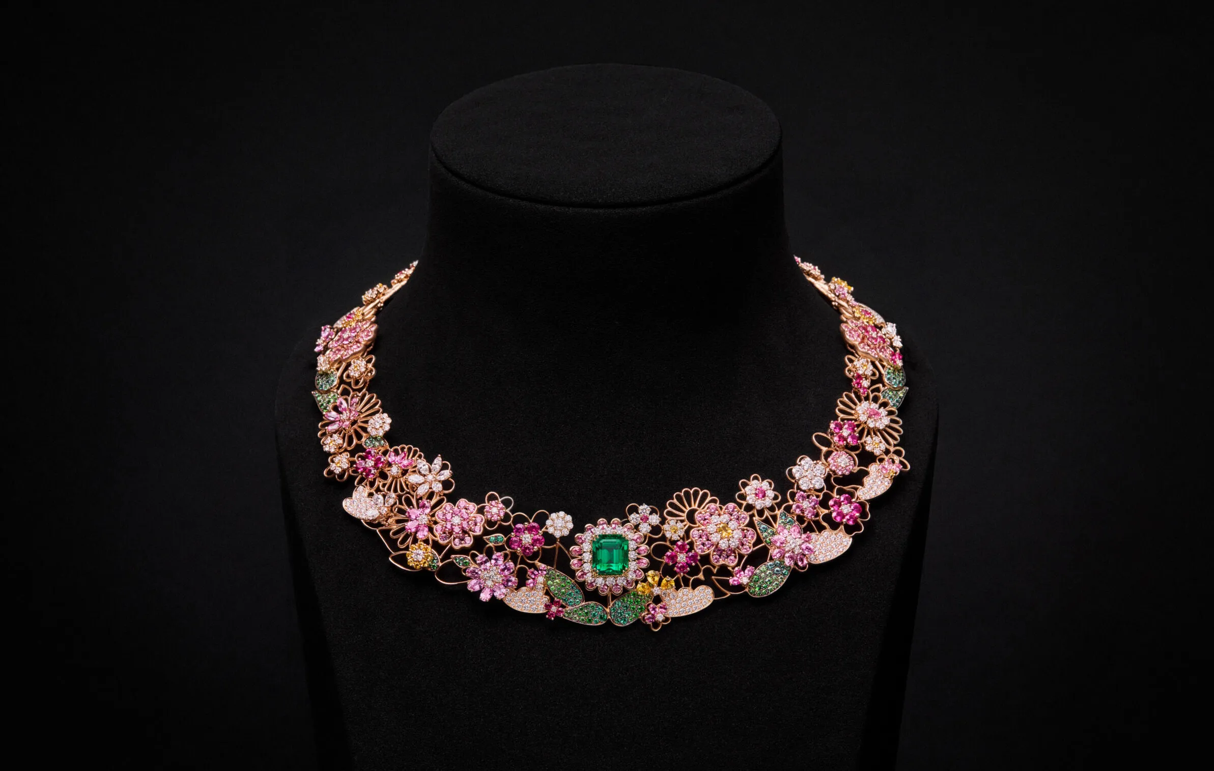 <p>The Manege Fleuri necklace with an emerald centre stone bordered by diamonds and pear-shaped pink sapphires, plus further gem-set flowers and leaves on a rose gold framework from the Dior Milly Dentelle High Jewellery collection. Photo credit Piotr Stoklosa</p>