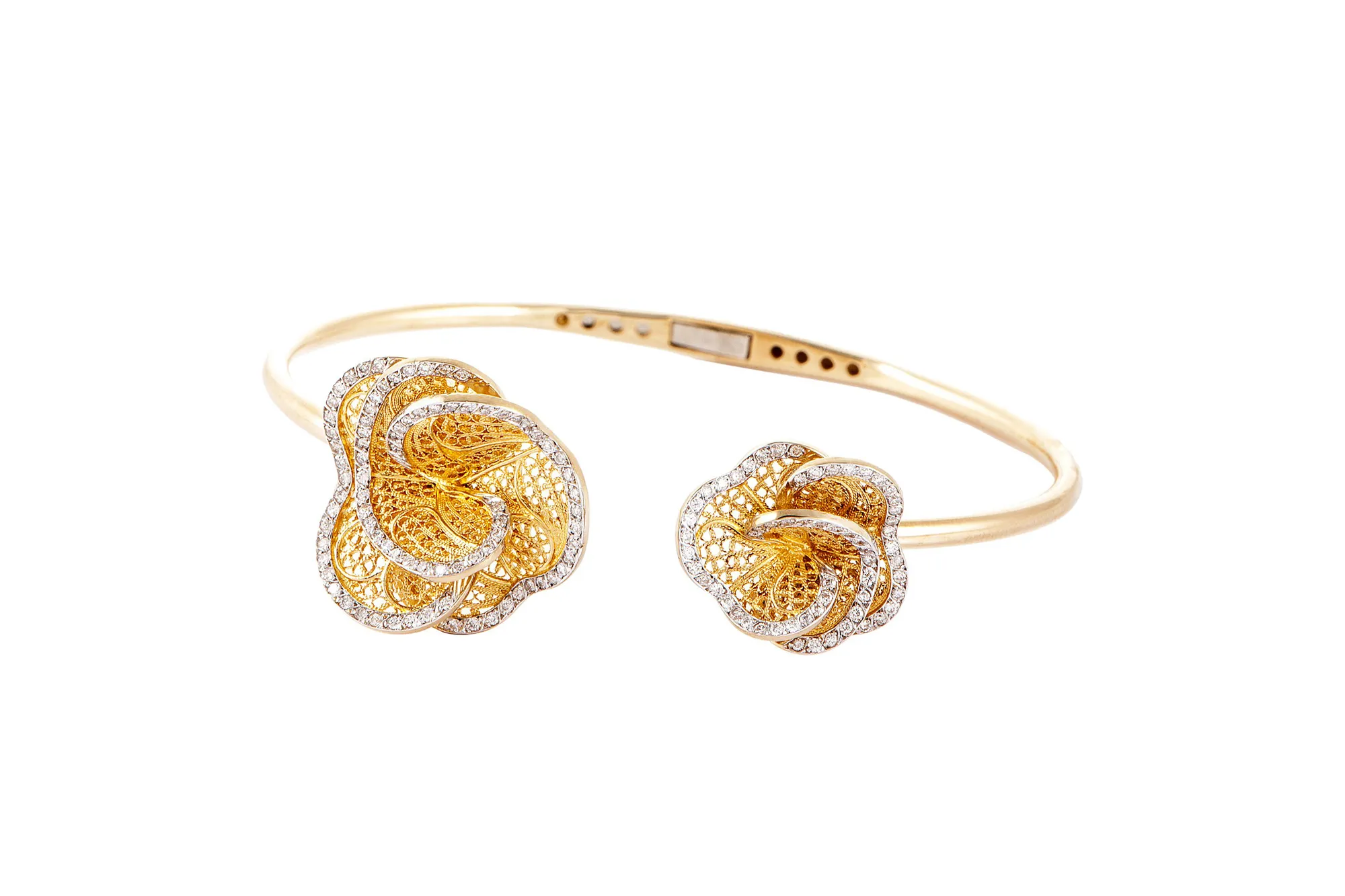 <p>Eleuterio ‘Blossom’ bangle in openwork yellow gold and diamonds</p>