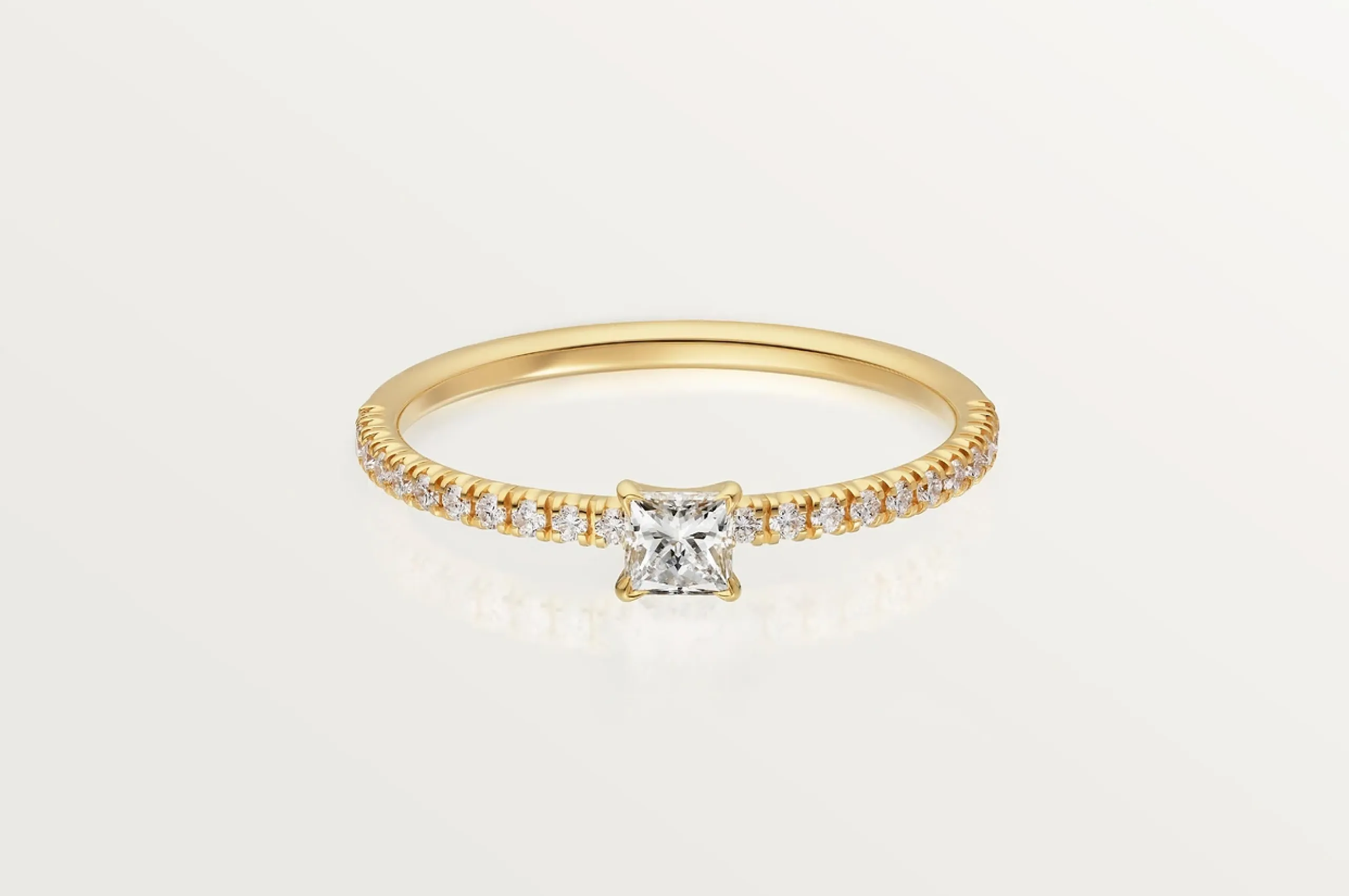 <p>Cartier’s dainty Etincelle de Cartier princess cut diamond ring in 18K yellow gold won’t outshine your future engagement ring.</p>