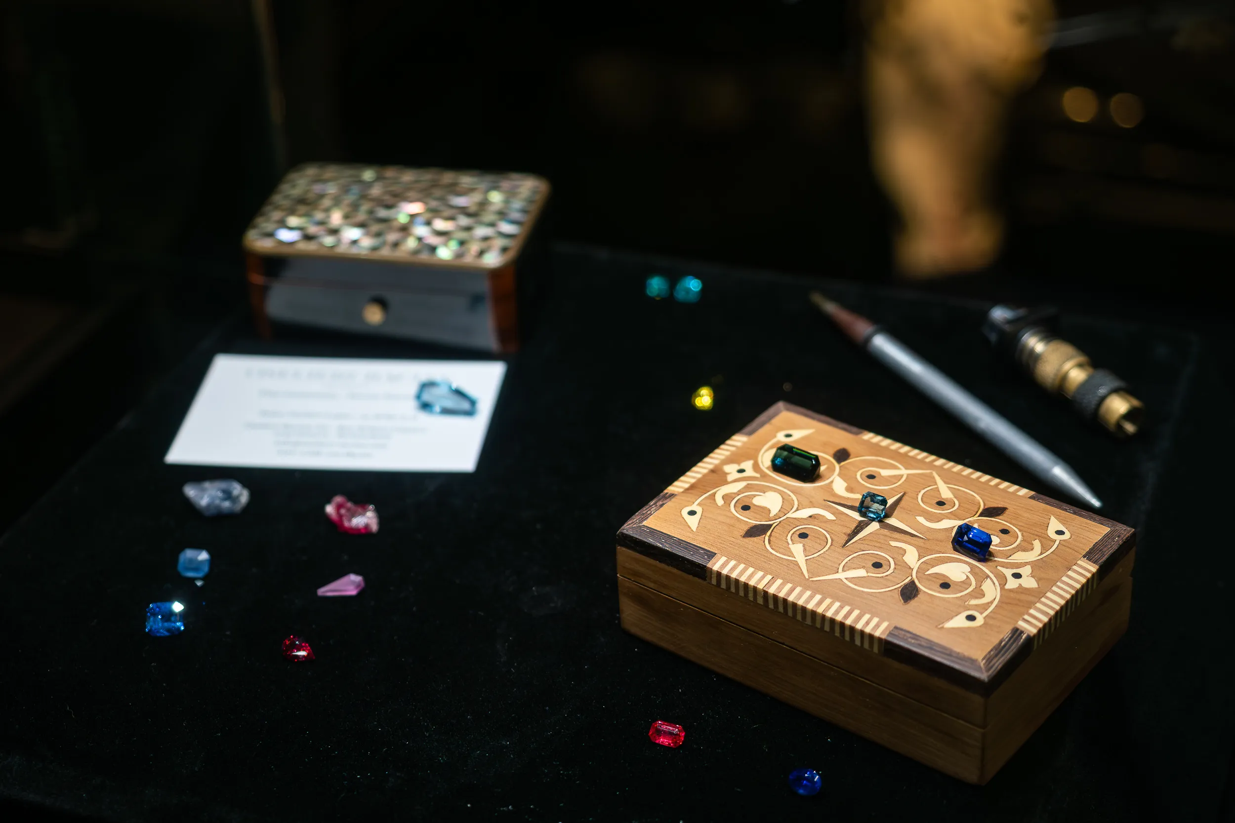 <p>Gemstones displayed on a marquetry box at GemGenève</p>