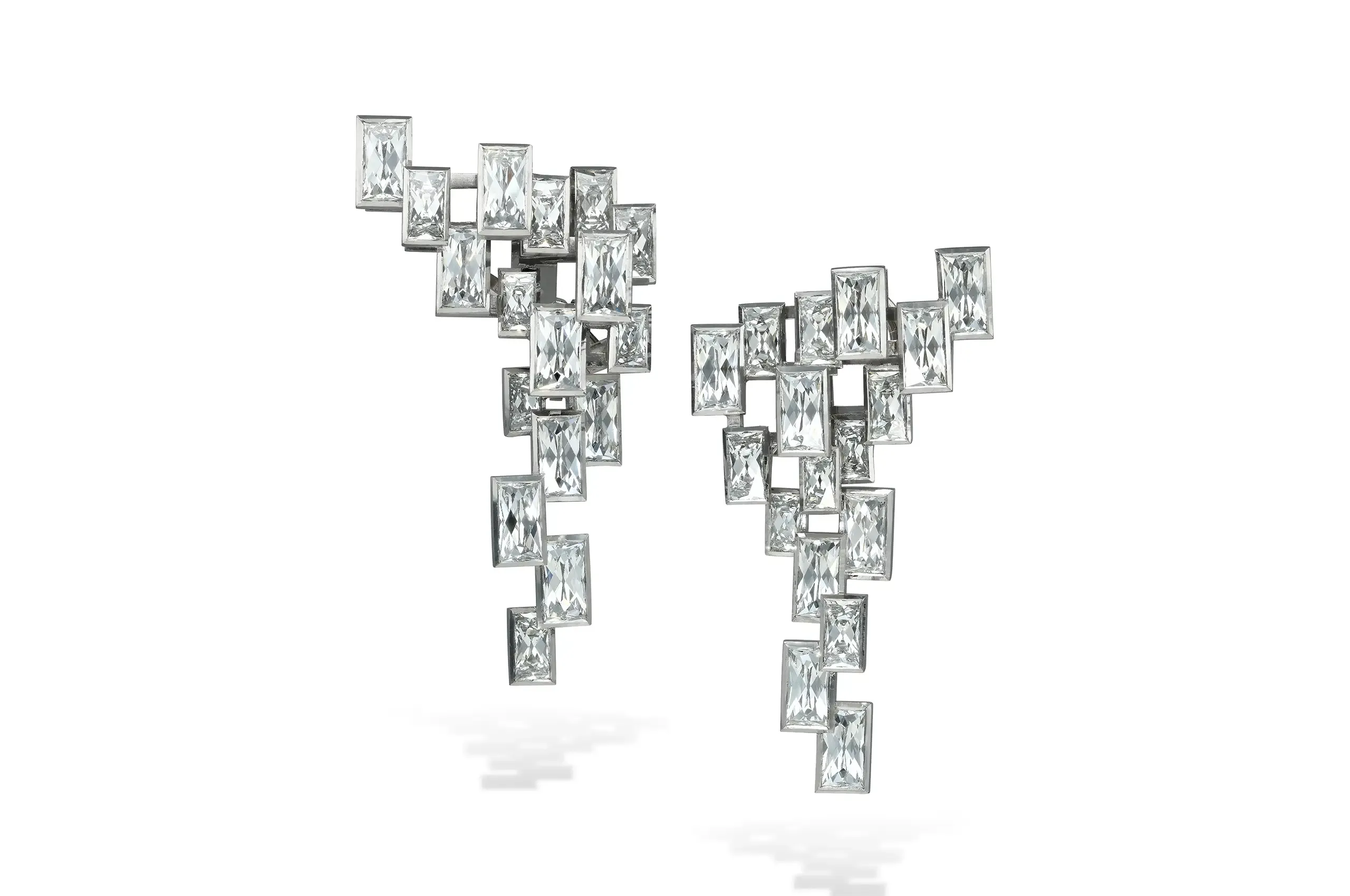 French cut diamond earrings inspired by Oscar Niemeyer’s architecture can be worn as shorter day earrings or with their full evening drops.