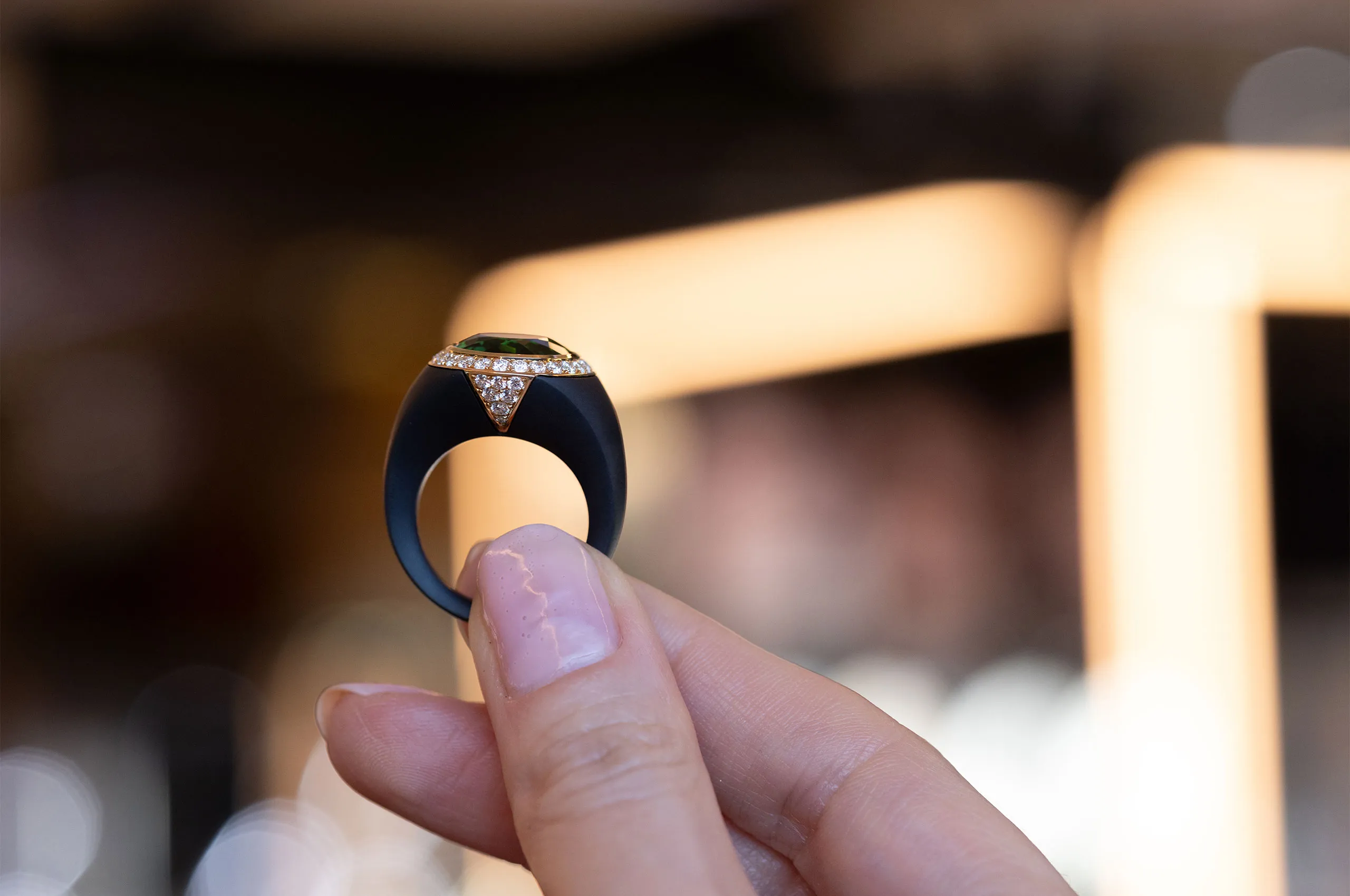 A closer look at the creative details of a Giorgio Visconti ring set with a central green tourmaline and diamonds in black titanium and rose gold 