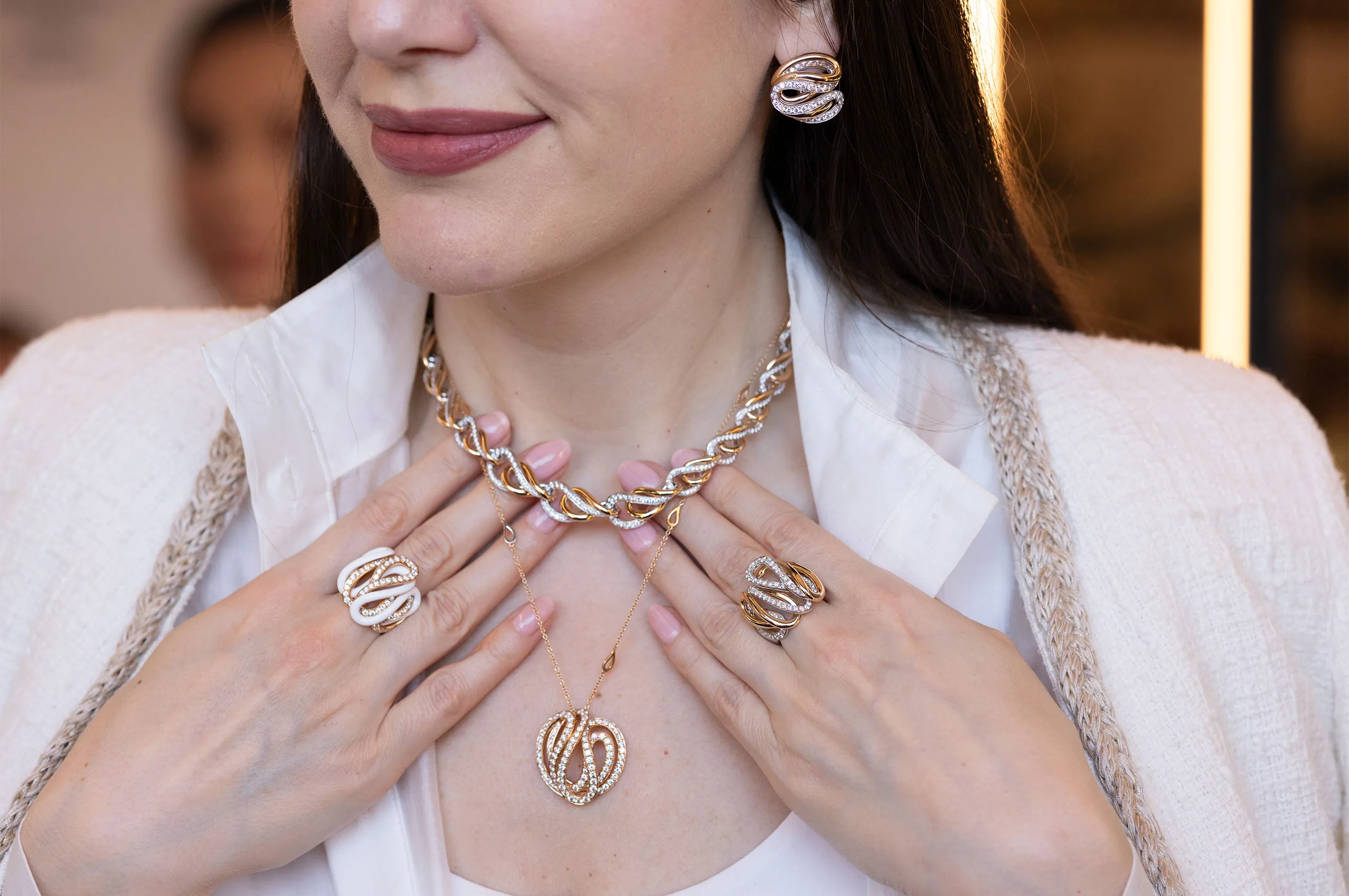 Katerina Perez wears pieces from the Giorgio Visconti Mamba collection, including pair of rings, a necklace, a pendant and matching earrings, all set with diamonds in rose and white gold 