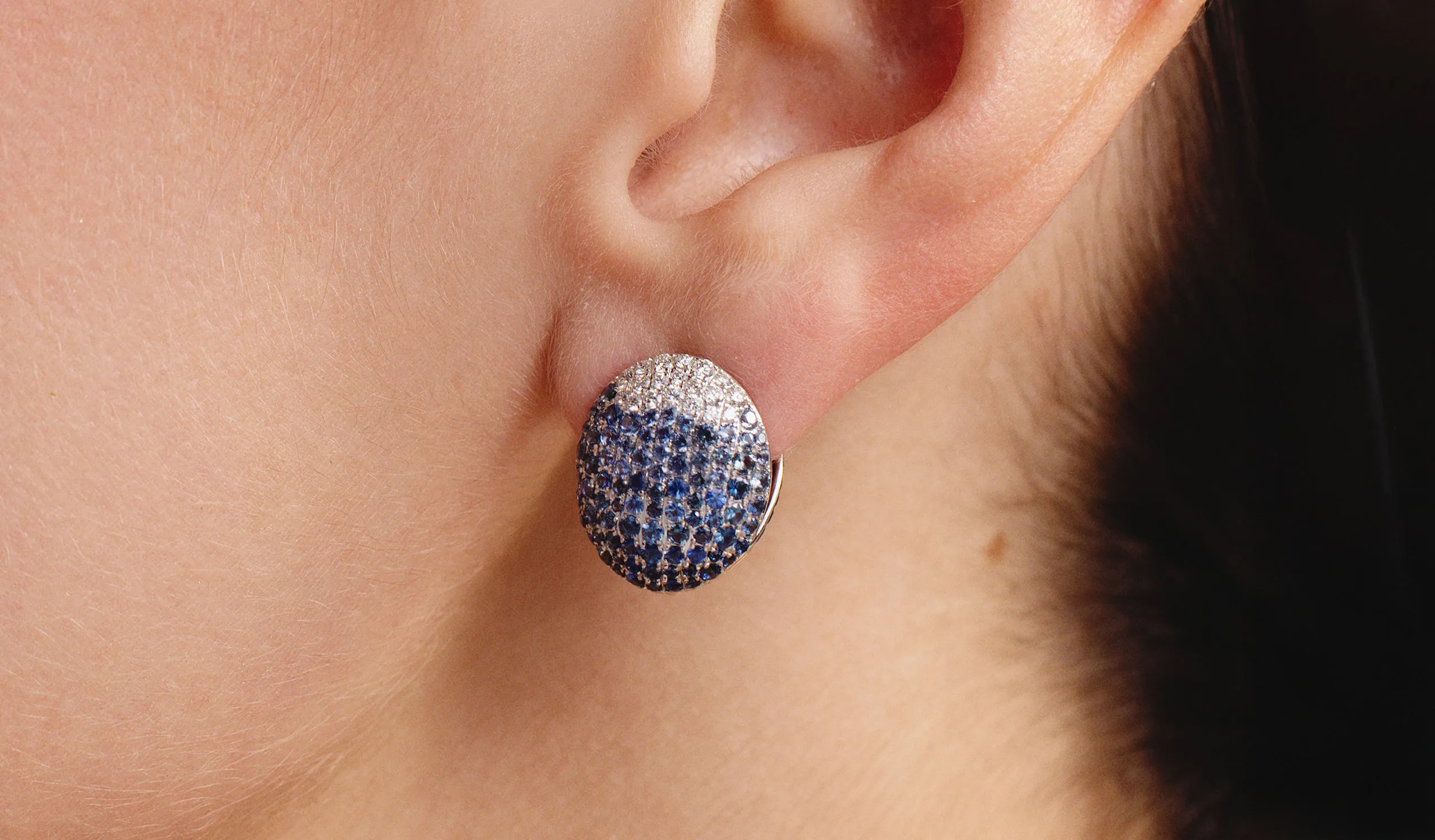 <p>A model wears a pair of Yami reversible oval-shaped earrings with sapphires and diamonds by Gyan Jaipur</p>
