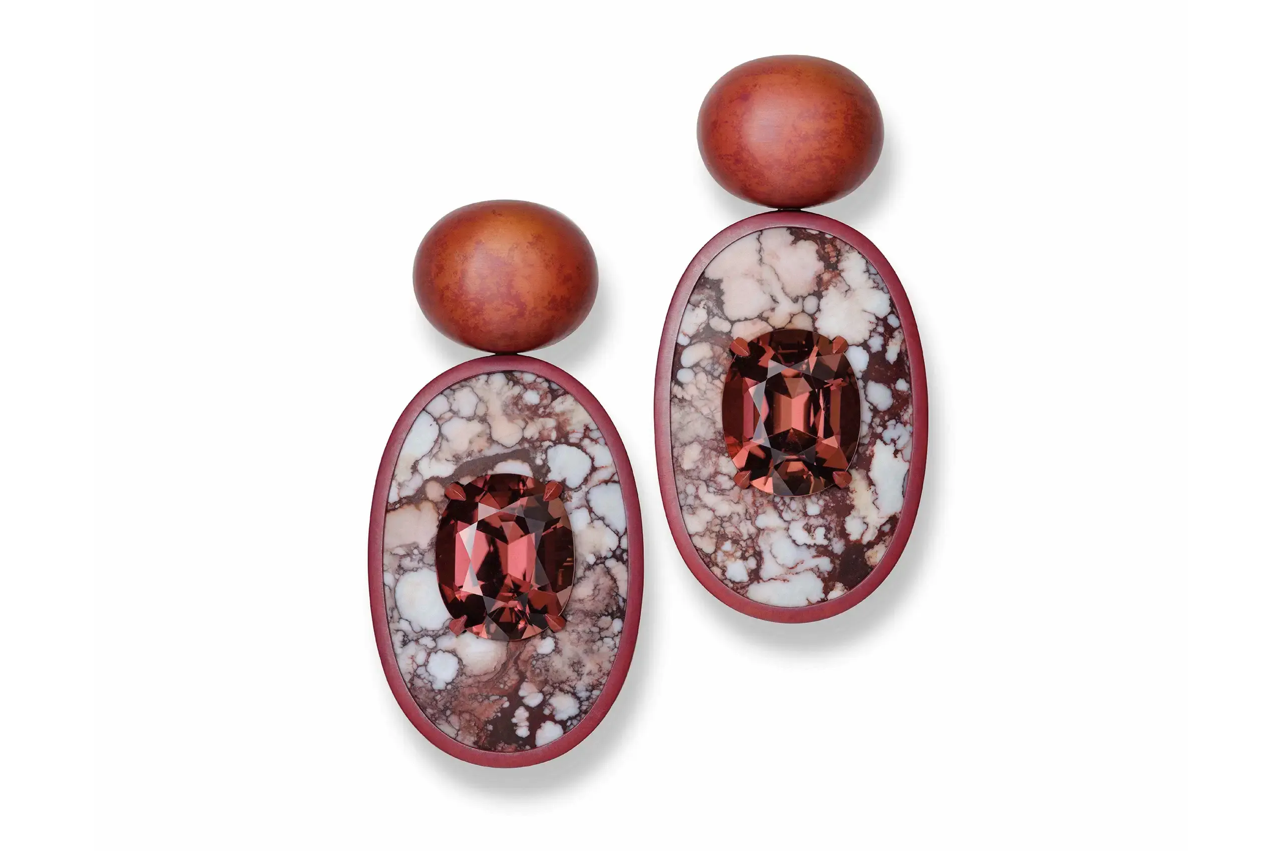 A creation by Hemmerle. A pair of earrings composed of tourmalines, magnesite and haematite discs, copper and white gold. Price on application.