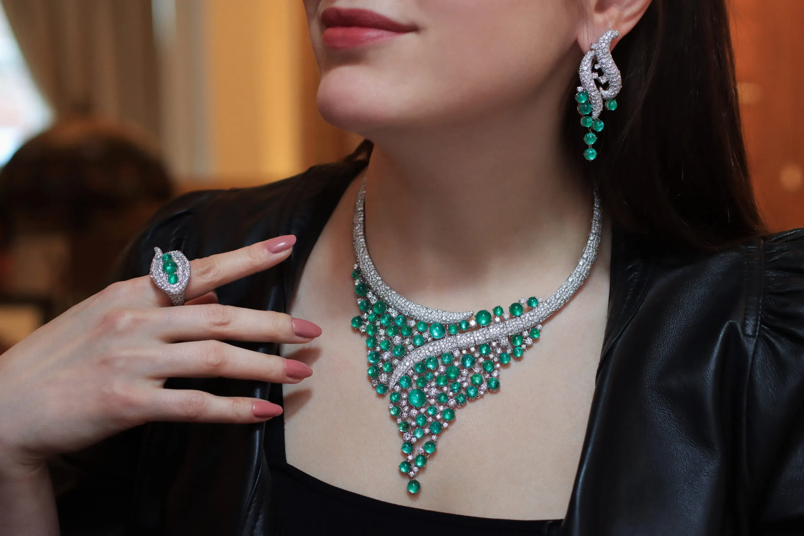 <p>Katerina Perez wears the AKANO Mkpulu suite including a necklace, earrings and a matching ring with diamonds and emeralds in 18k gold </p>