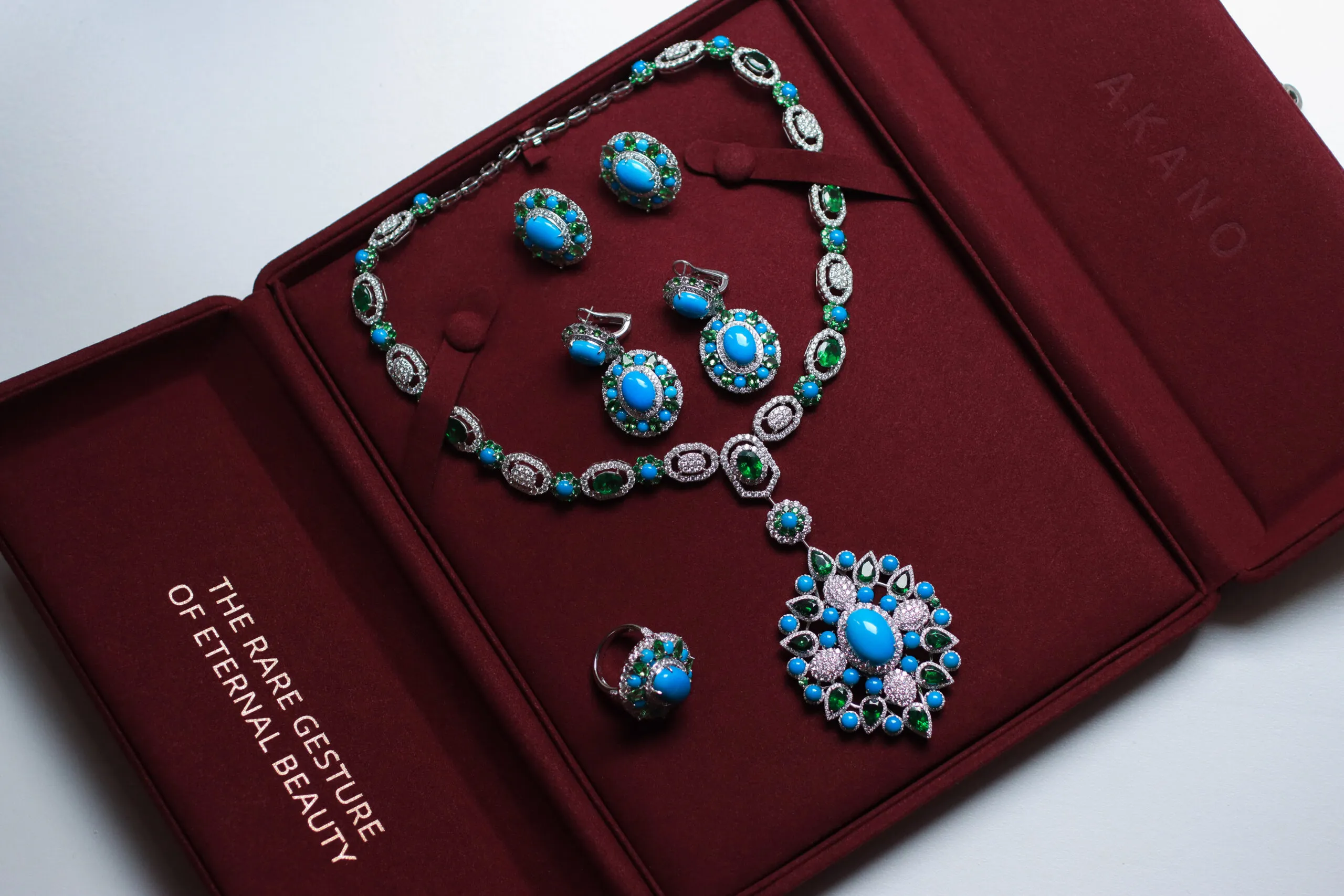 <p>AKANO Chikaodili suite complete with a necklace, ring and earrings set with round turquoise, tsavorite, and diamonds in 18k gold </p>