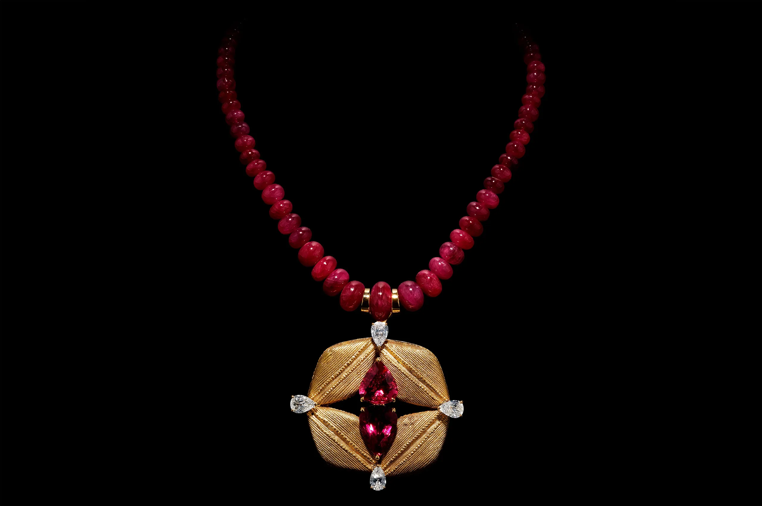 Glenn Spiro’s Baoulé Ruby Necklace from the Materials of the Old World collection, centred on an antique Baoulé gold element and set with rubellites, diamonds and graduated ruby beads.