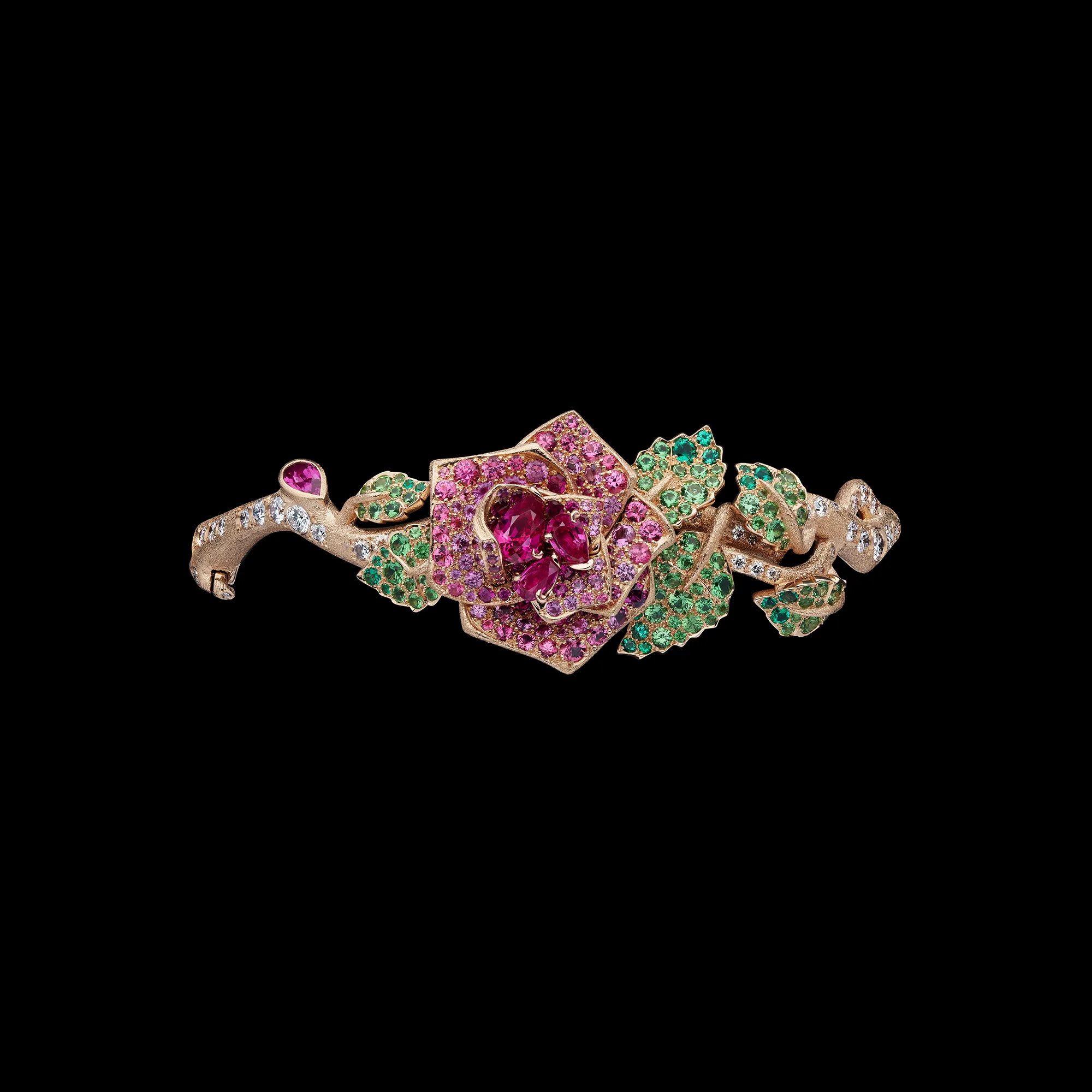 <p>A rose-inspired creation from the Dior Milly Dentelle High Jewellery collection set with emeralds, demantoids, rubies, pink sapphires, and diamonds in textured gold </p>
