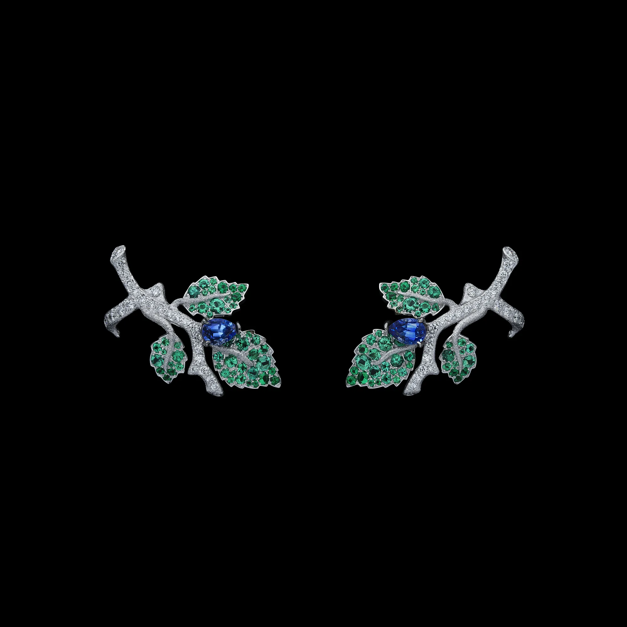 <p>A pair of earrings with oval-shaped sapphires, gem-set leaves and textured white gold branches from the Dior Milly Dentelle High Jewellery collection</p>