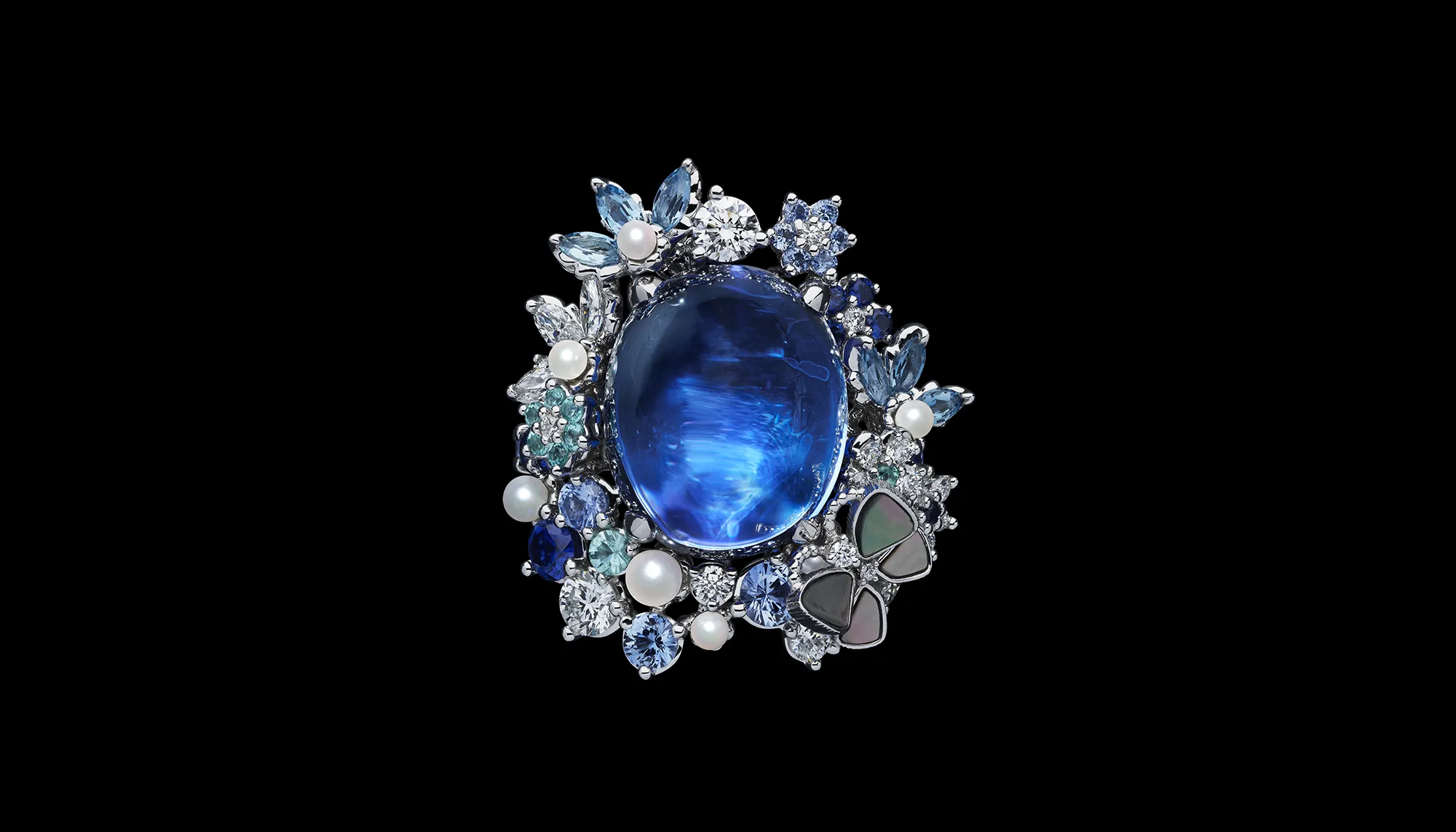 <p>The Dior Milly Dentelle High Jewellery collection features significant gemstones, including this large sapphire cabochon surrounded by micro-pearls, further sapphires, mother of pearl inlay and round brilliant-cut diamonds </p>
