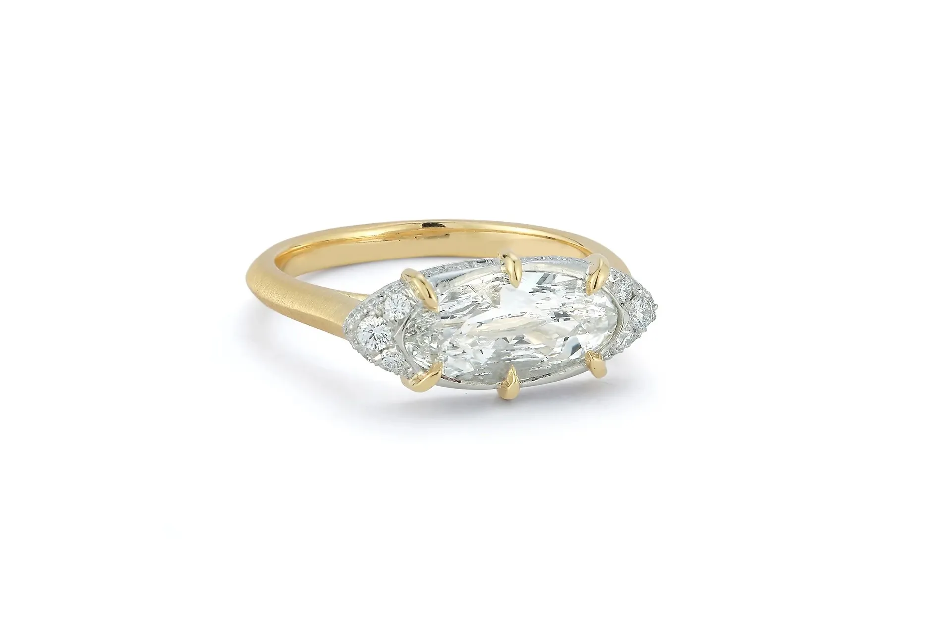 <p>Jade Trau Mariam east west engagement ring with a 1.50 carat oval diamond set in 18K yellow gold.</p>