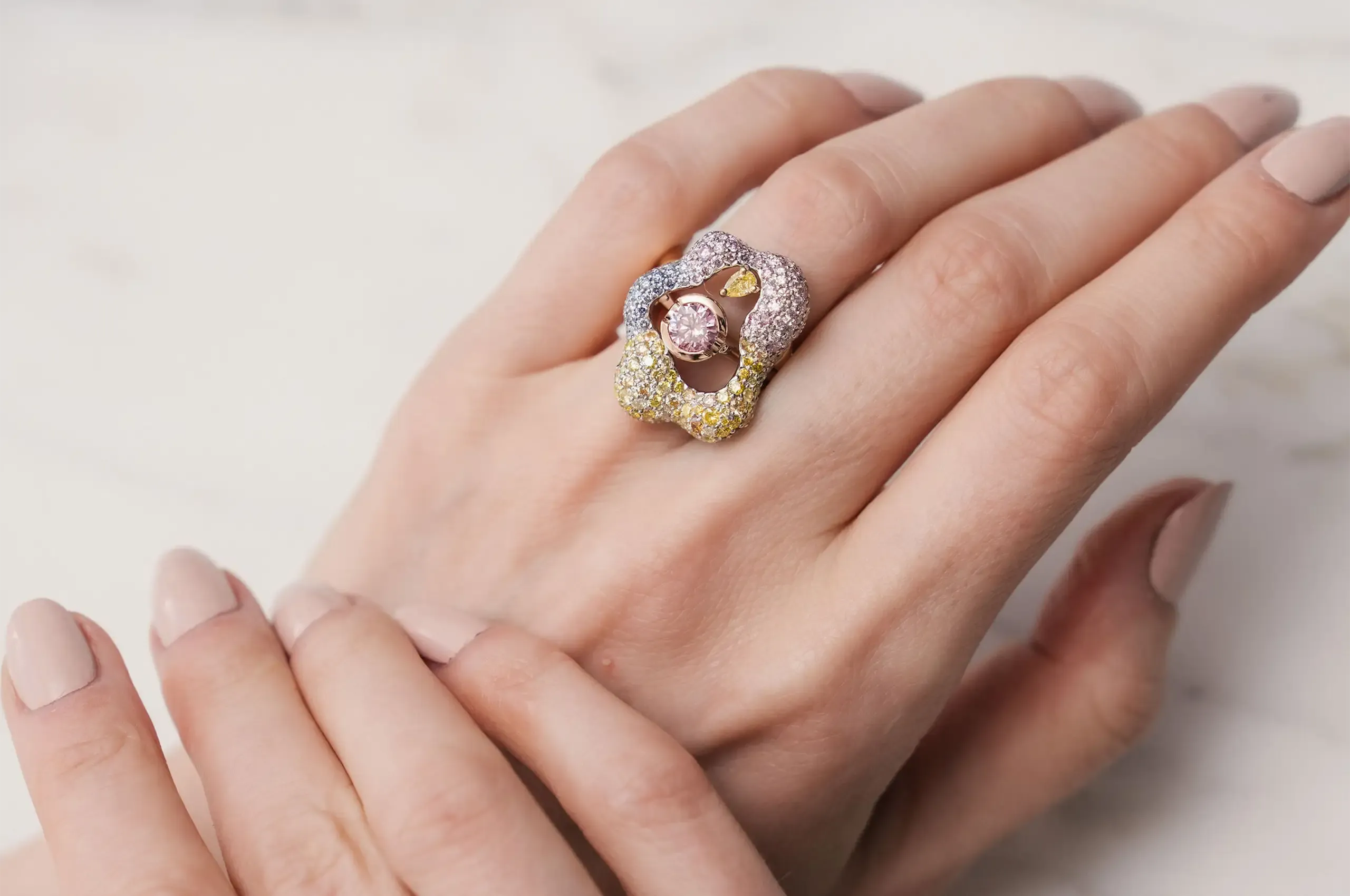 The removable diamond-set jacket of Entwined, inspired by coral and marine life, transforms an Argyle pink diamond solitaire into a colourful cocktail ring