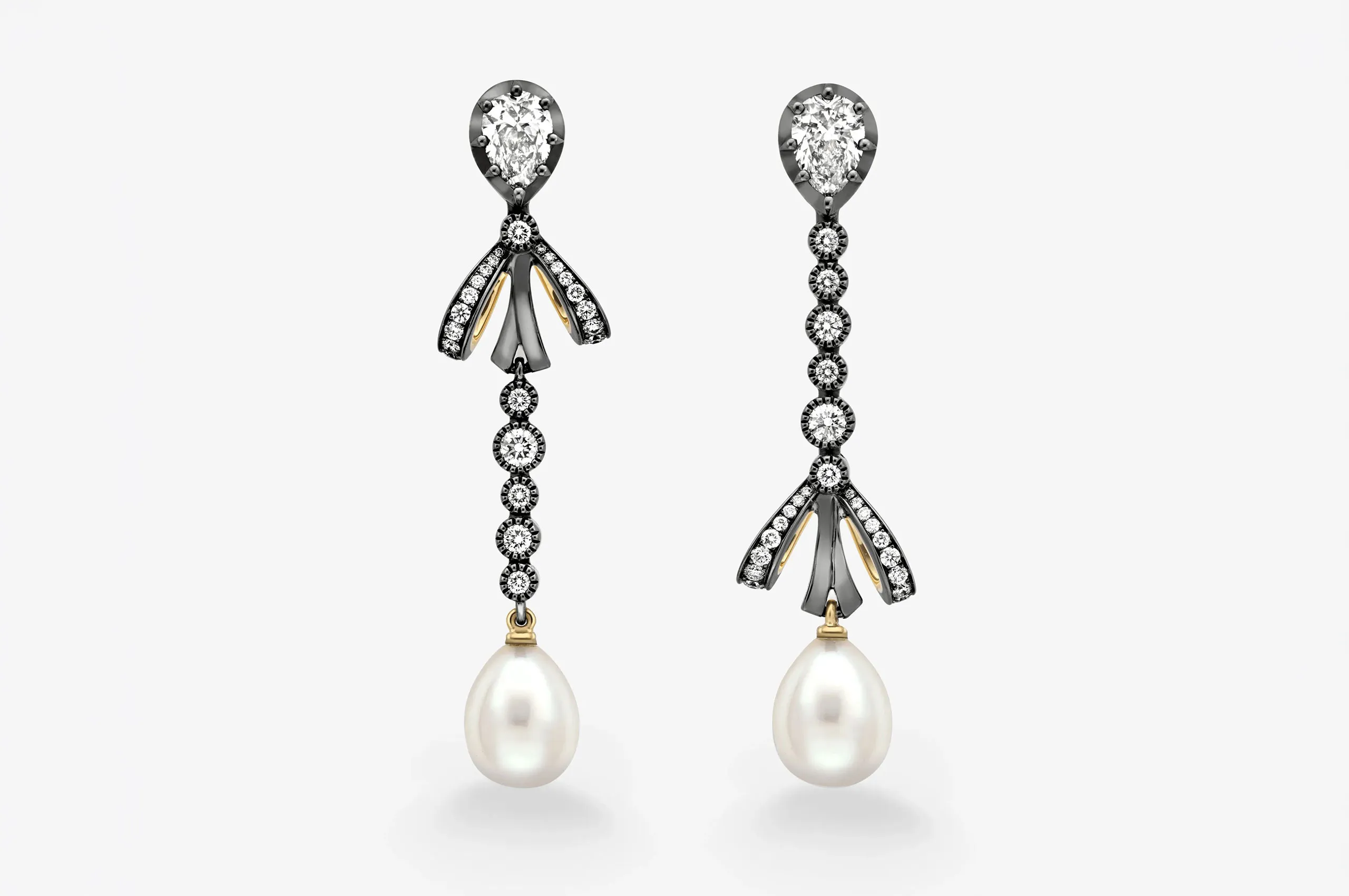 The Round Brilliant Cut Diamond & Pearl Gypset Hoop Earrings use intricate millegrain detailing to add texture and definition to the setting.