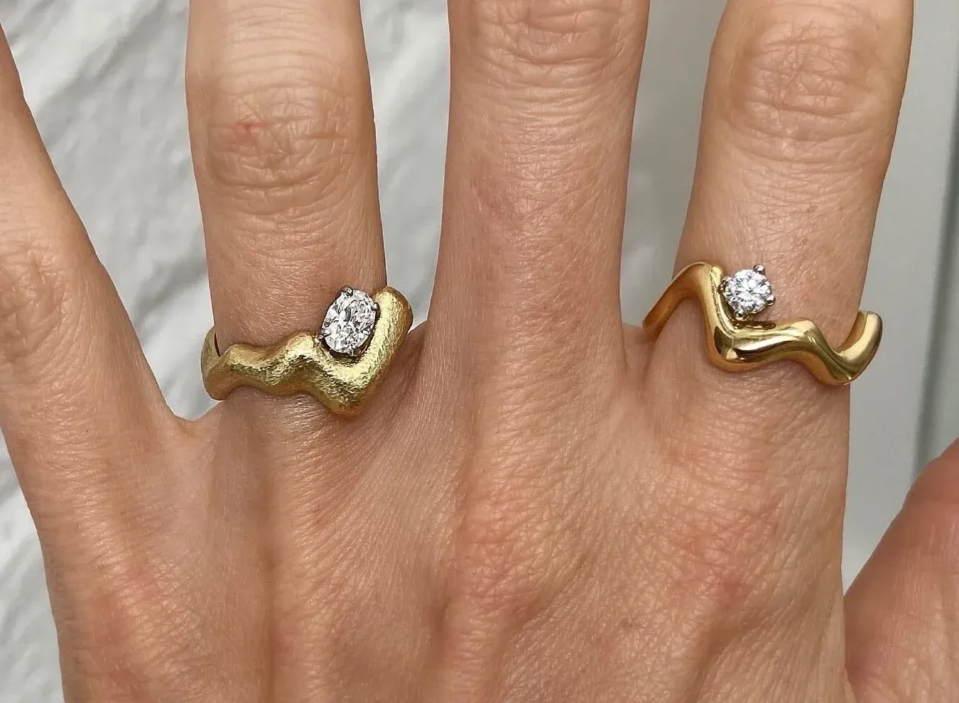 Jessie Thomas' sculptural curved rings with floating diamonds in 18K yellow gold