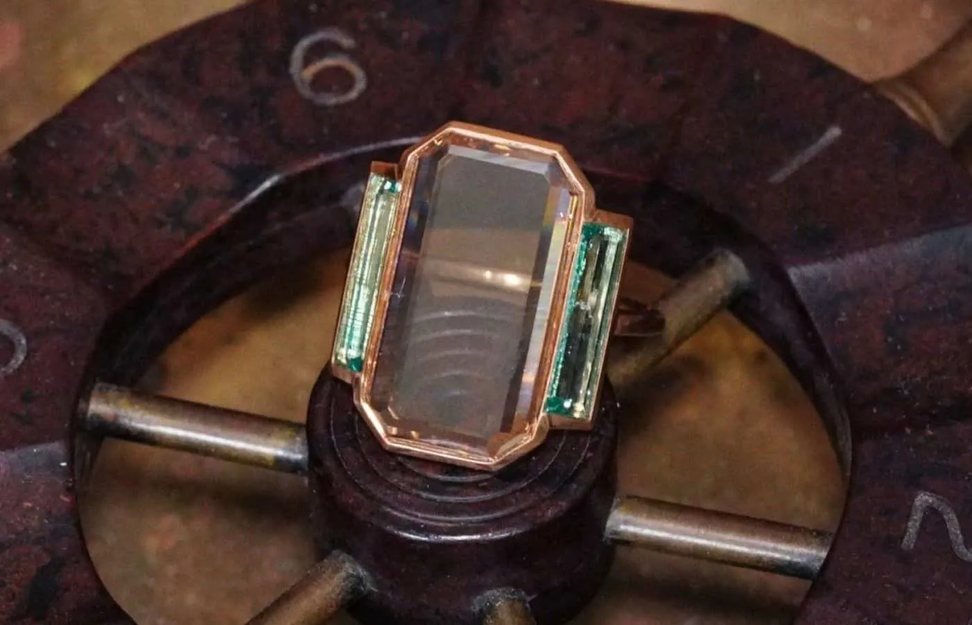 <p> Jogani Art Deco-inspired ring with a 7.12 carat portrait-cut diamond and two step-cut emeralds in 20k rose gold </p>