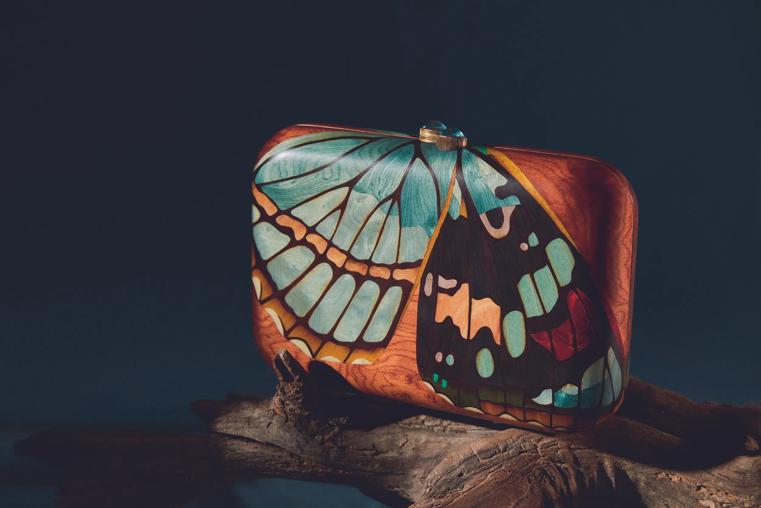 <p>Silvia Furmanovich Butterfly clutch in wood marquetry with yellow gold and blue topaz</p>
