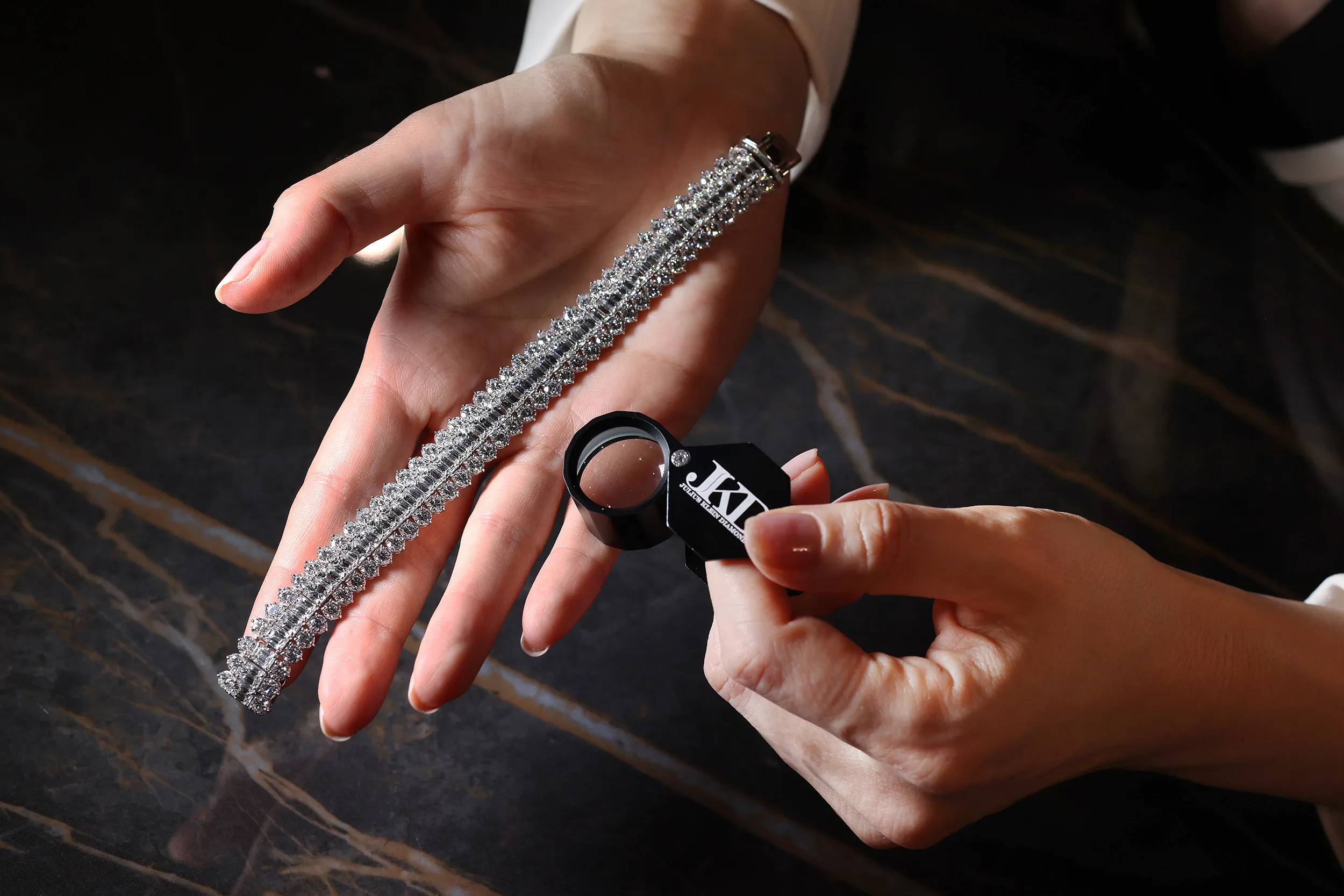 <p>An emerald cut and round diamond high jewellery bracelet by Julius Klein</p>
