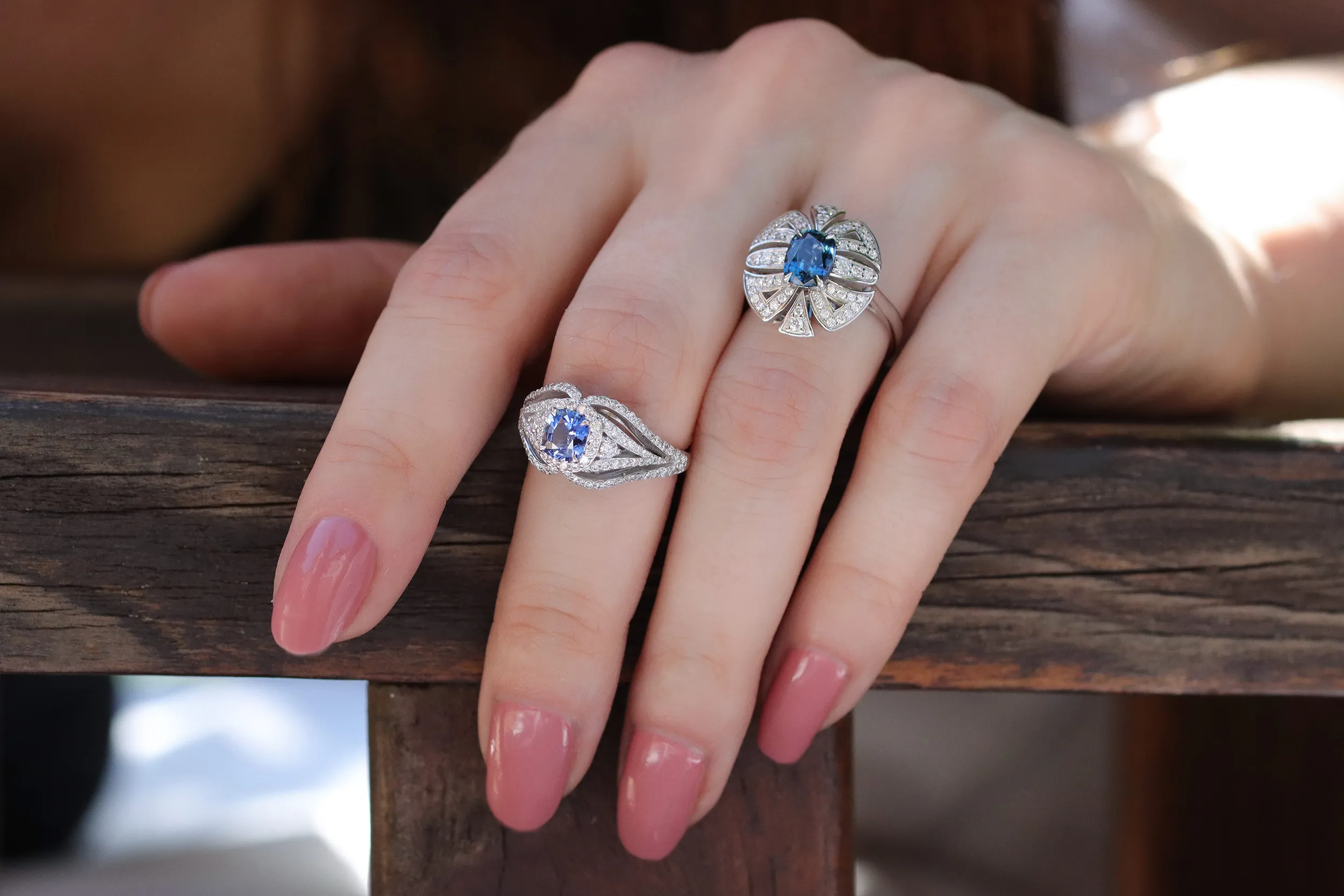 <p>Morebelli cocktail rings including a 0.70 carat blue sapphire from Ilakaka, Madagascar, surrounded by 100 diamonds totalling 0.67 carats (left), and a 1.22 carat blue sapphire ring from the same location with 54 diamonds totalling 0.31 carats, both set in 18k white gold </p>