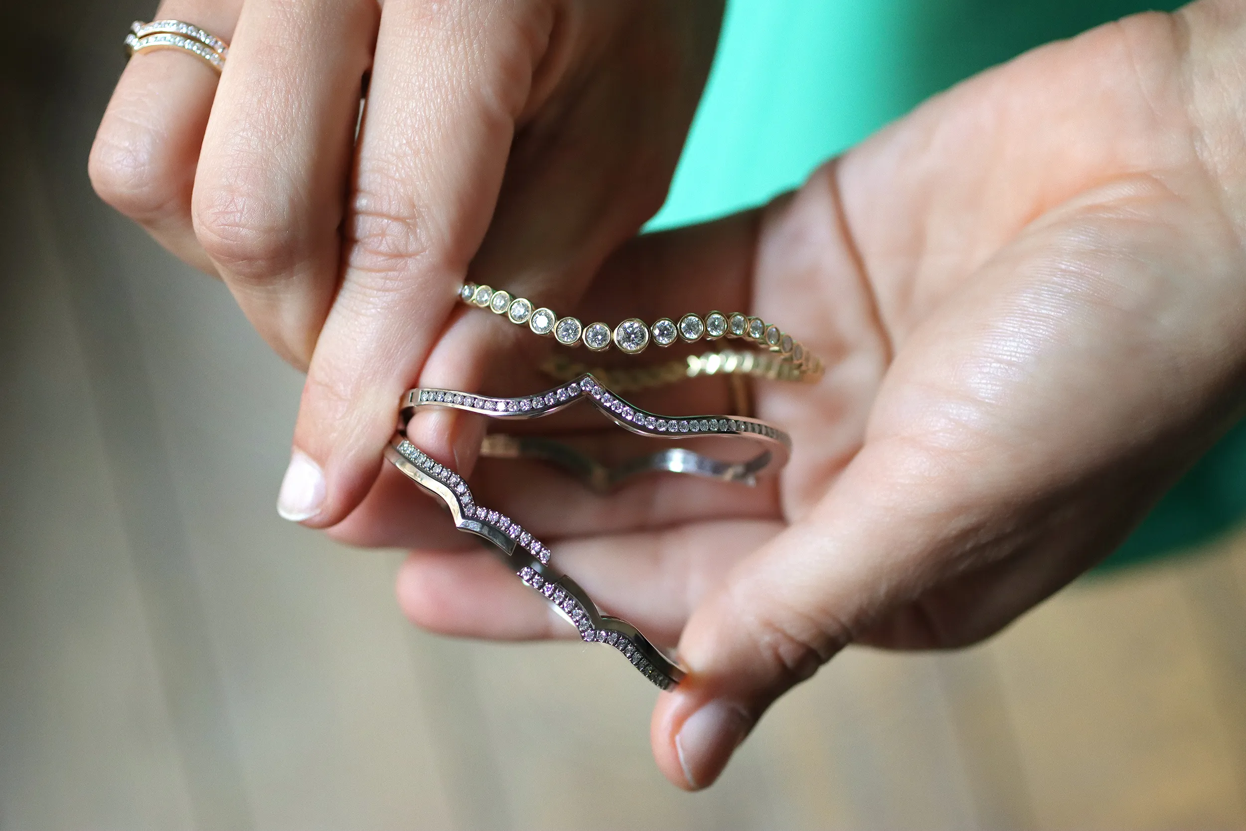 <p>A selection of Cherituelle bangles including (from top to bottom) the Ondine Signature bangle, the Jeri bangle, and the Jeri Signature bangle in a mix of 18k yellow and white gold</p>