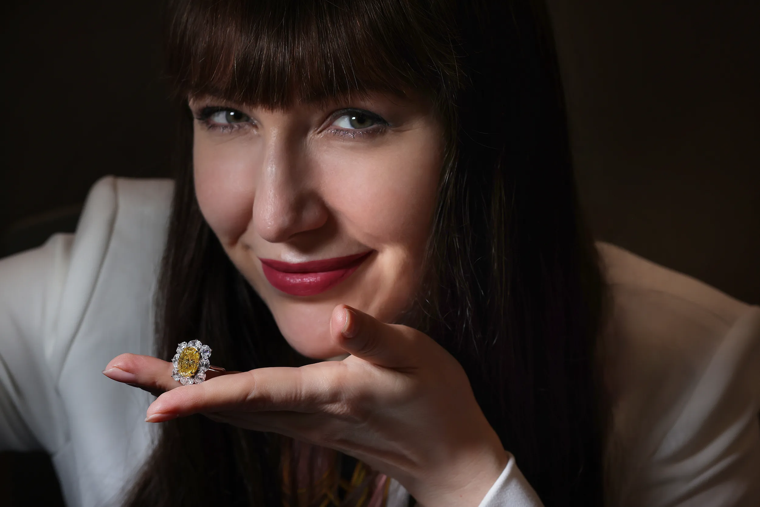 <p>Julius Klein cluster ring, set with a 6 carat Vivid Yellow oval cut diamond, surrounded by eight colourless oval diamonds</p>
