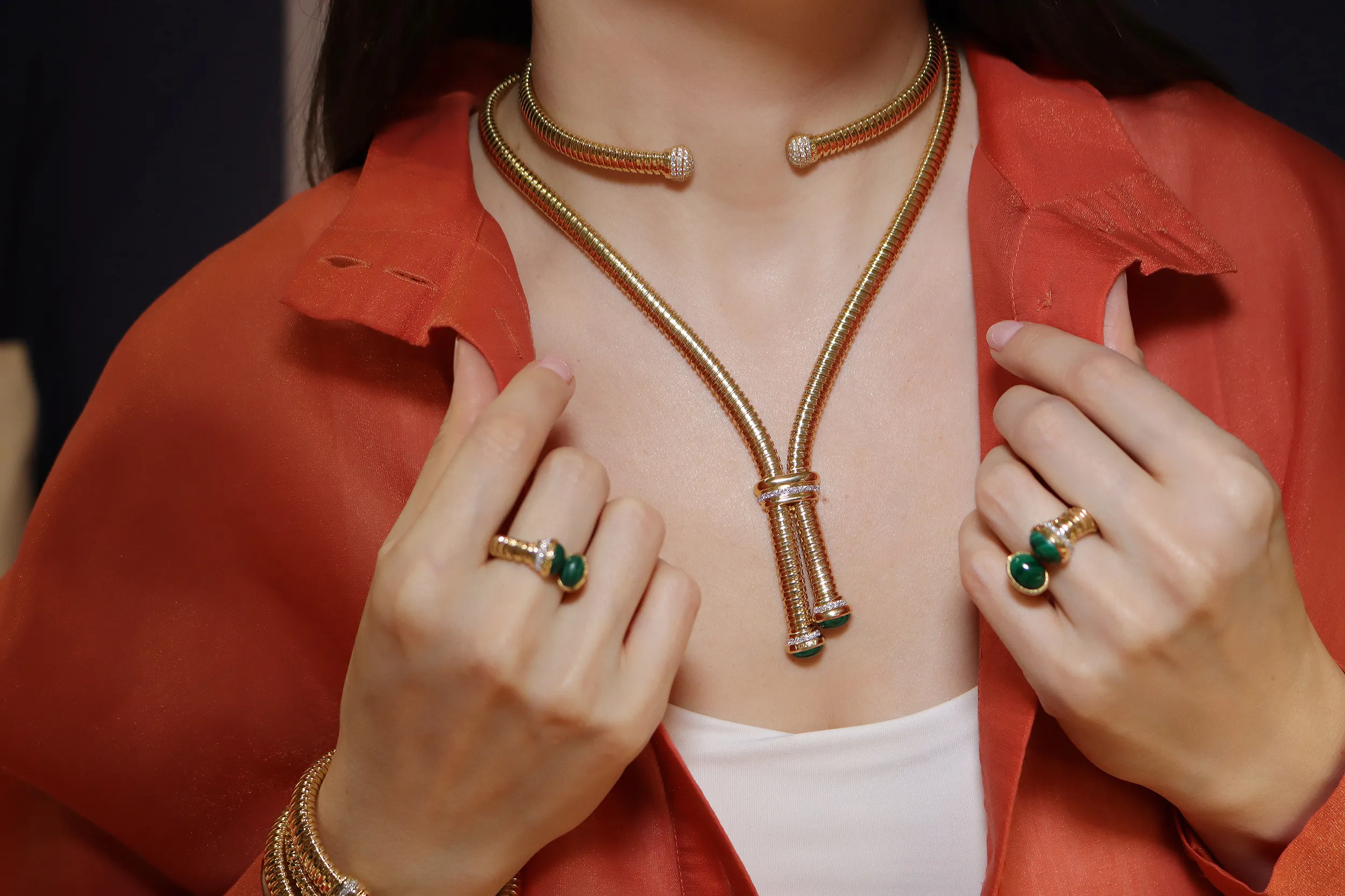 <p>Katerina Perez wears the HIMO Jewellery Tourbillon collection, including an 18k yellow gold necklace, choker and rings set with diamonds and malachite</p>
