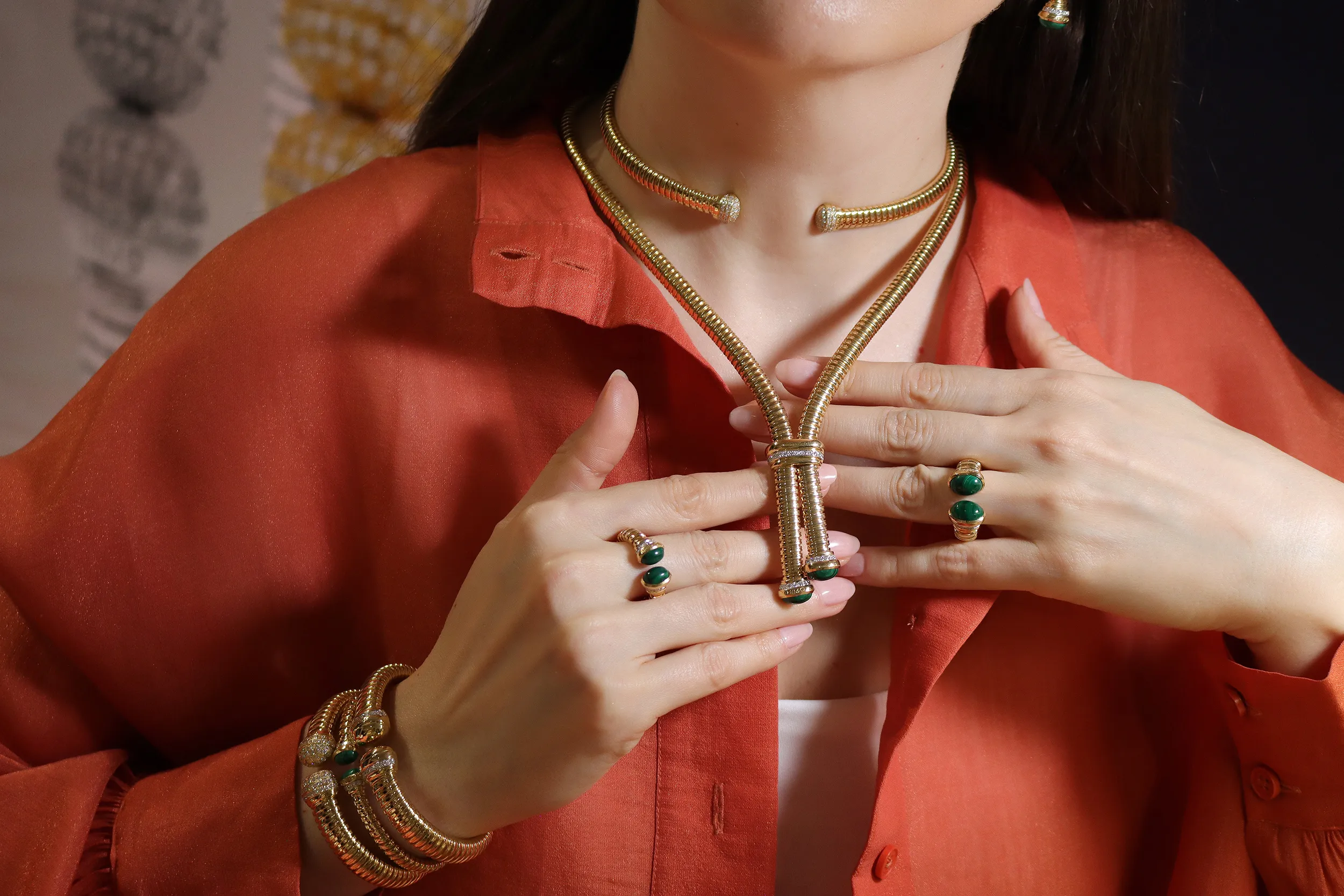 <p>Katerina Perez wears the HIMO Jewellery Tourbillon necklace in 18k yellow gold with diamonds and malachite, alongside a matching pair of rings, choker necklace and bracelets</p>